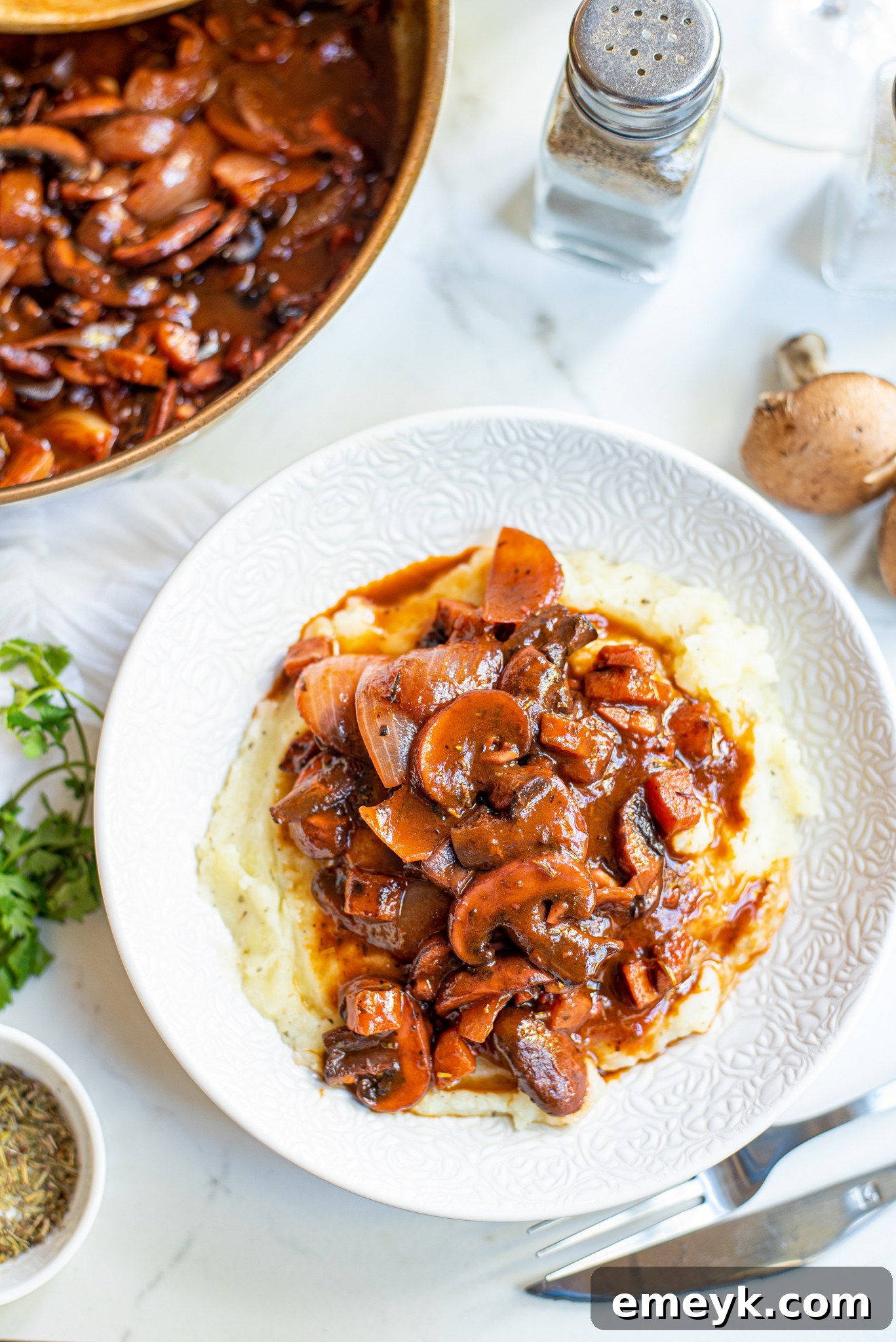 Mushroom Bourguignon beautifully plated on a white dish, ready to eat.