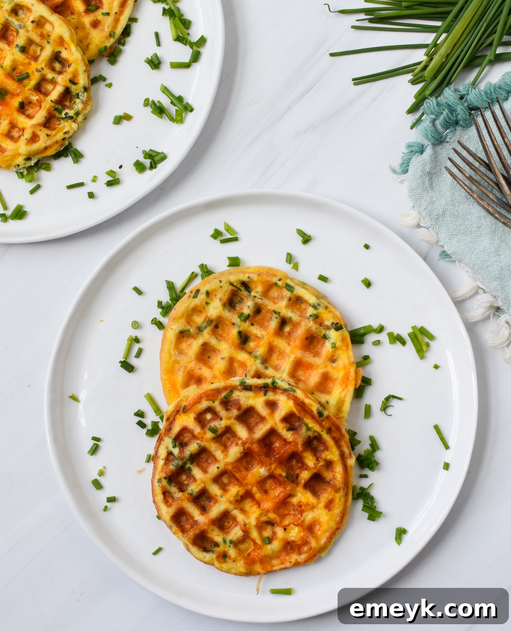 A bowl of chaffle batter seasoned with fresh herbs, ready for the waffle iron.