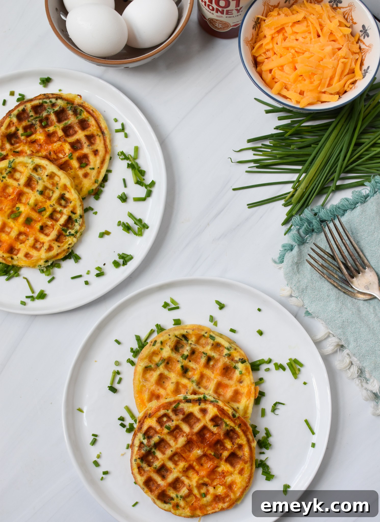 A freshly cooked chaffle being cut with a fork, showing its fluffy interior and crispy exterior.