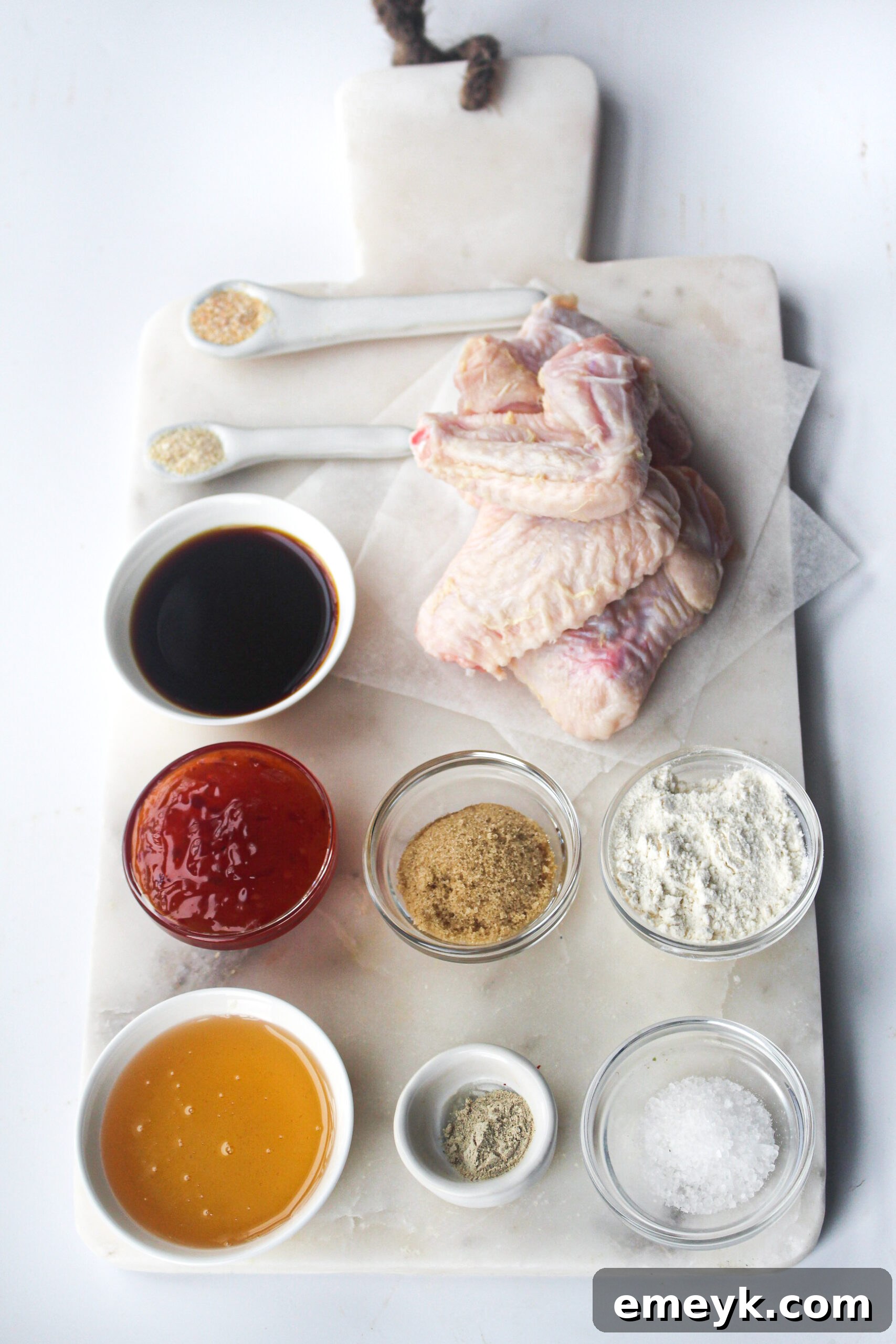 Ingredients for Air Fryer Chicken Wings Recipe including spices, honey, and sauces.