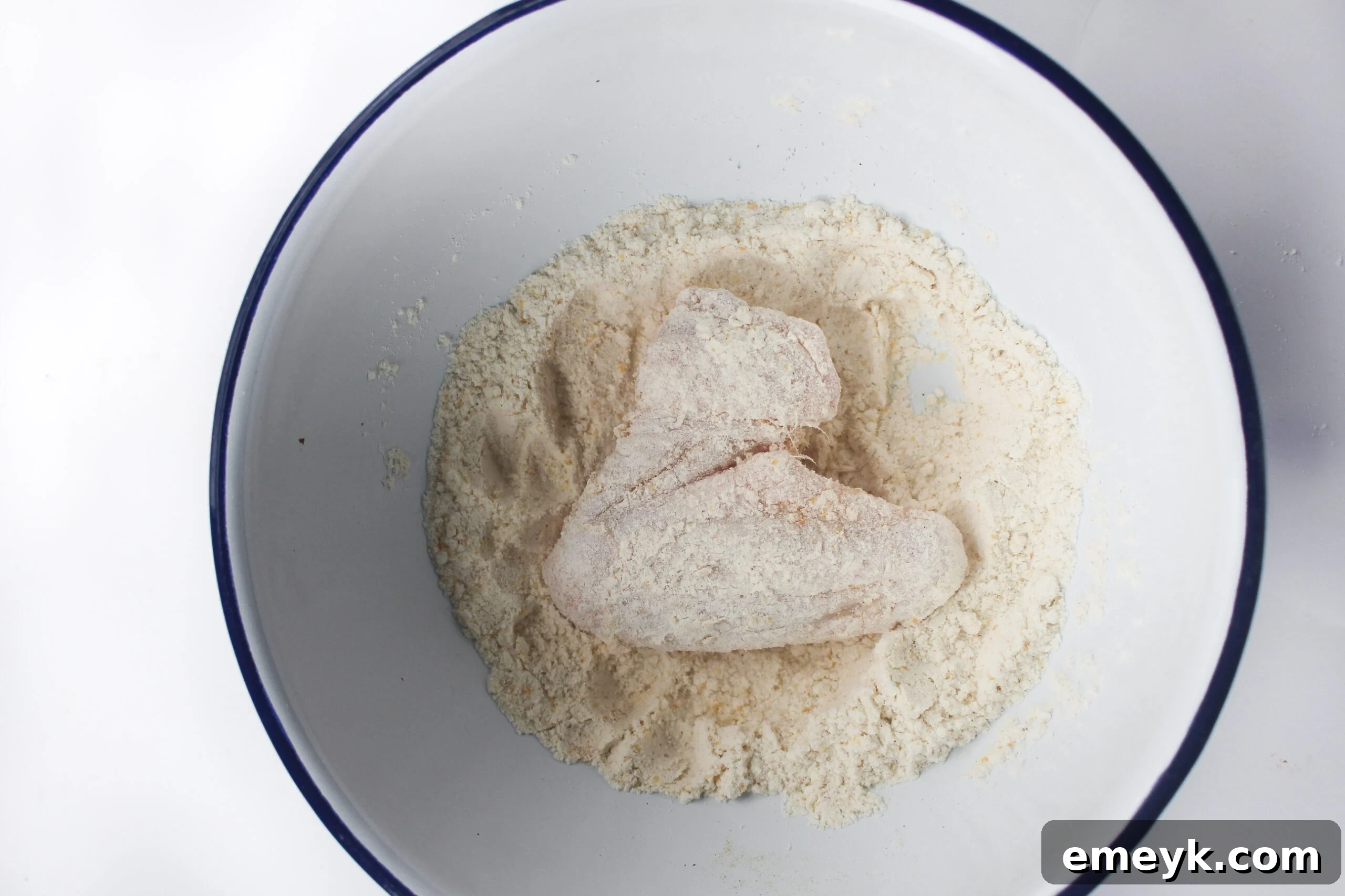 Air Fryer Chicken Wings Recipe with flour on the wings in a bowl.