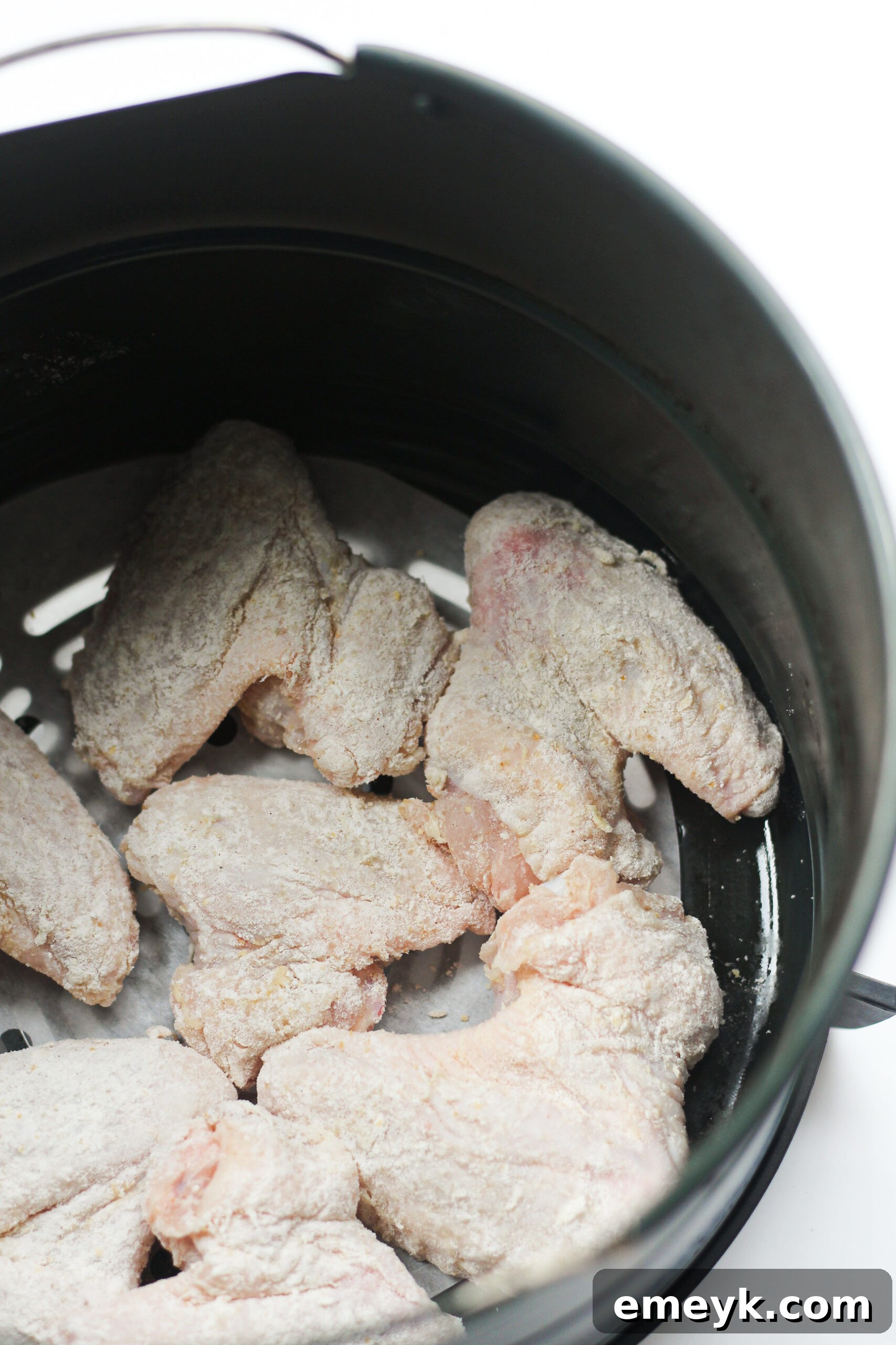 Air Fryer Chicken Wings Recipe cooking in the air fryer.
