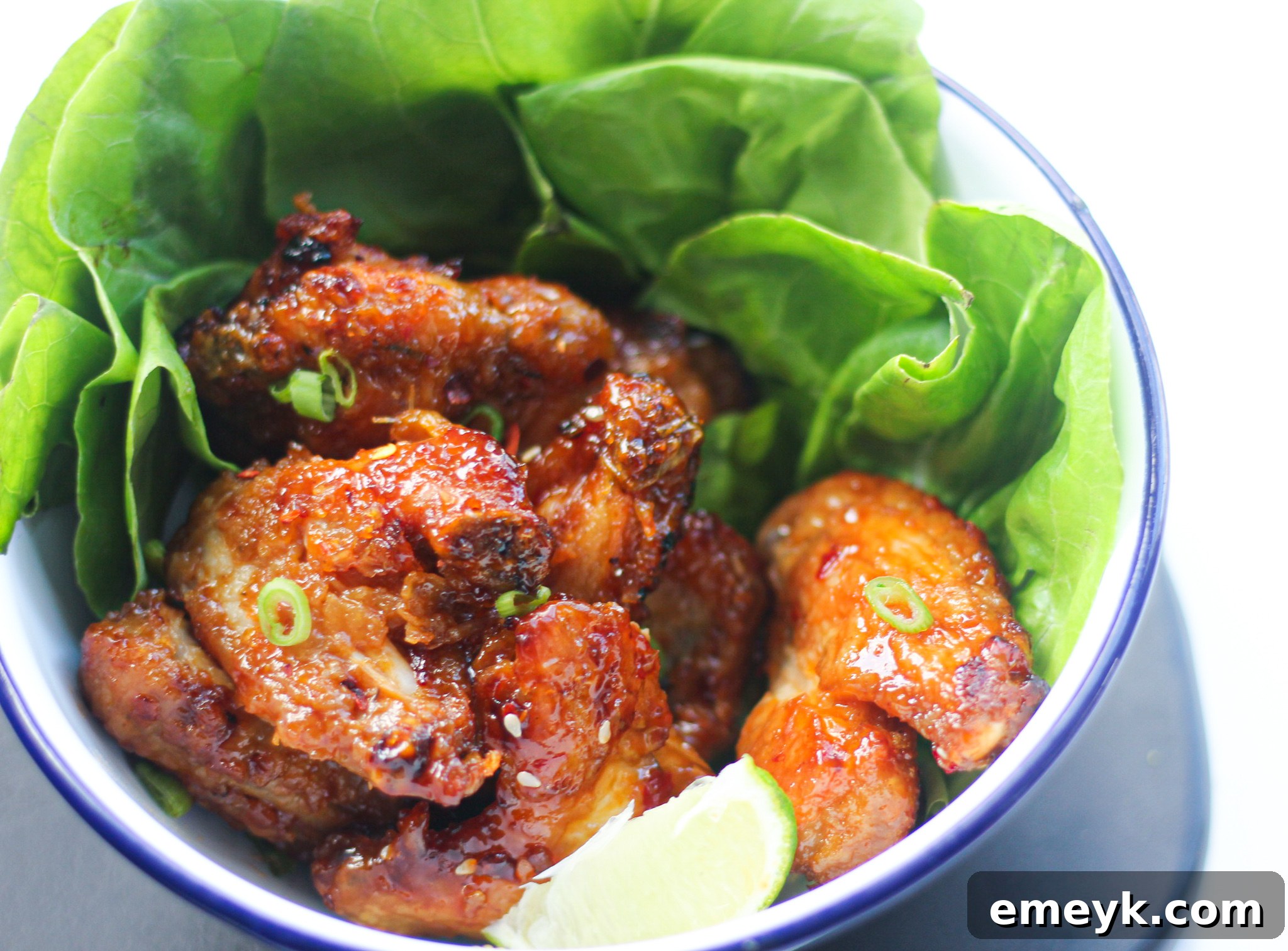 Air Fryer Chicken Wings Recipe with lettuce and lemon wedges.