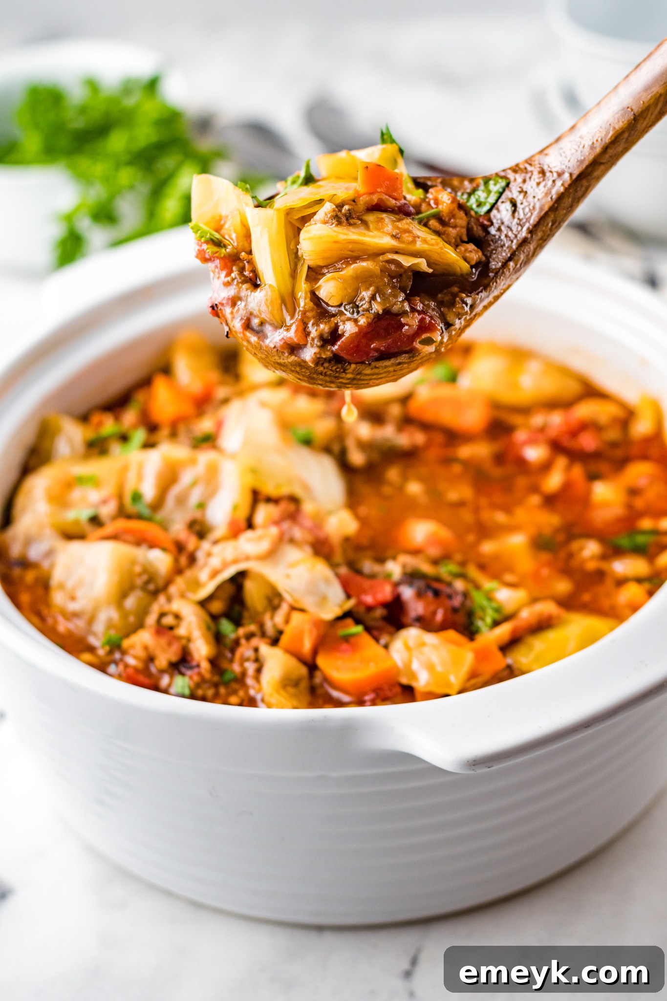 Unrolled Cabbage Soup 2 A steaming pot of hearty Cabbage Roll Soup, garnished with fresh parsley.