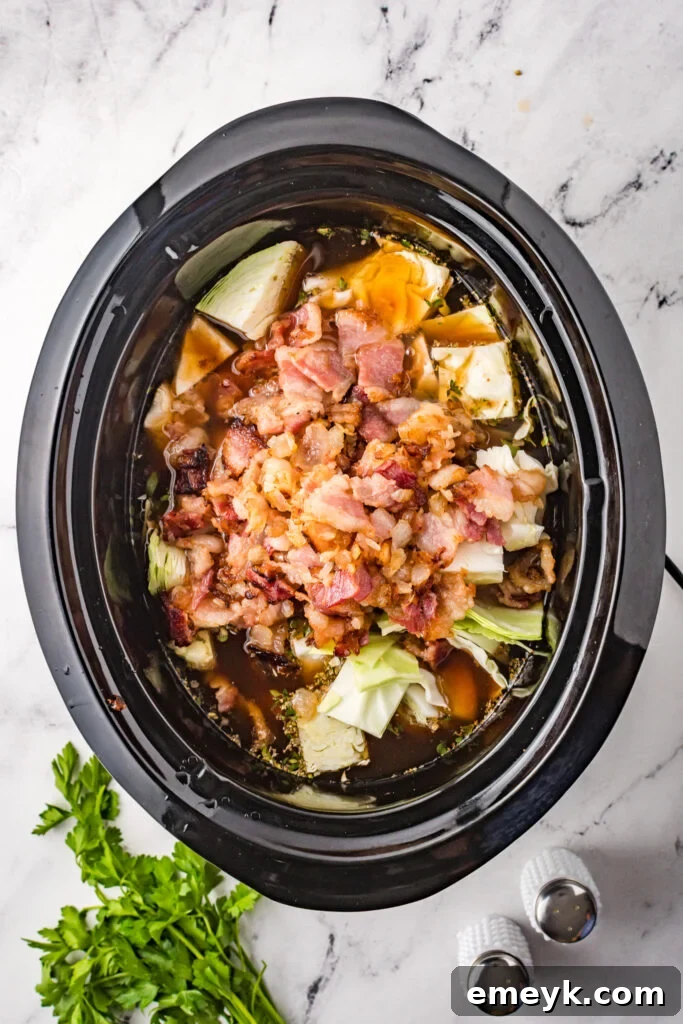 Unrolled Cabbage Soup 5 Cabbage Roll Soup simmering in a slow cooker.