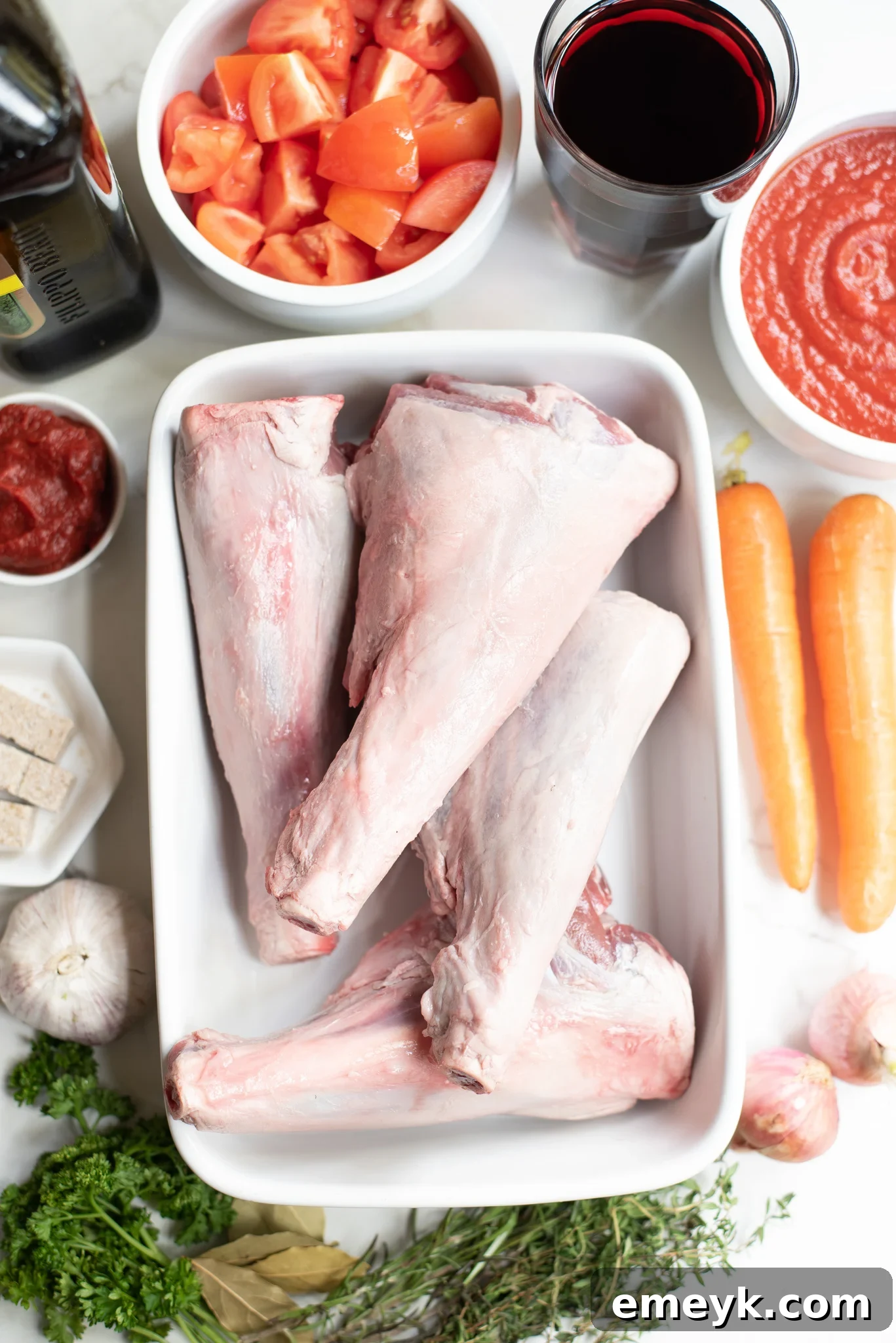 Fresh ingredients for Braised Lamb Shanks Recipe, including lamb, vegetables, and herbs.