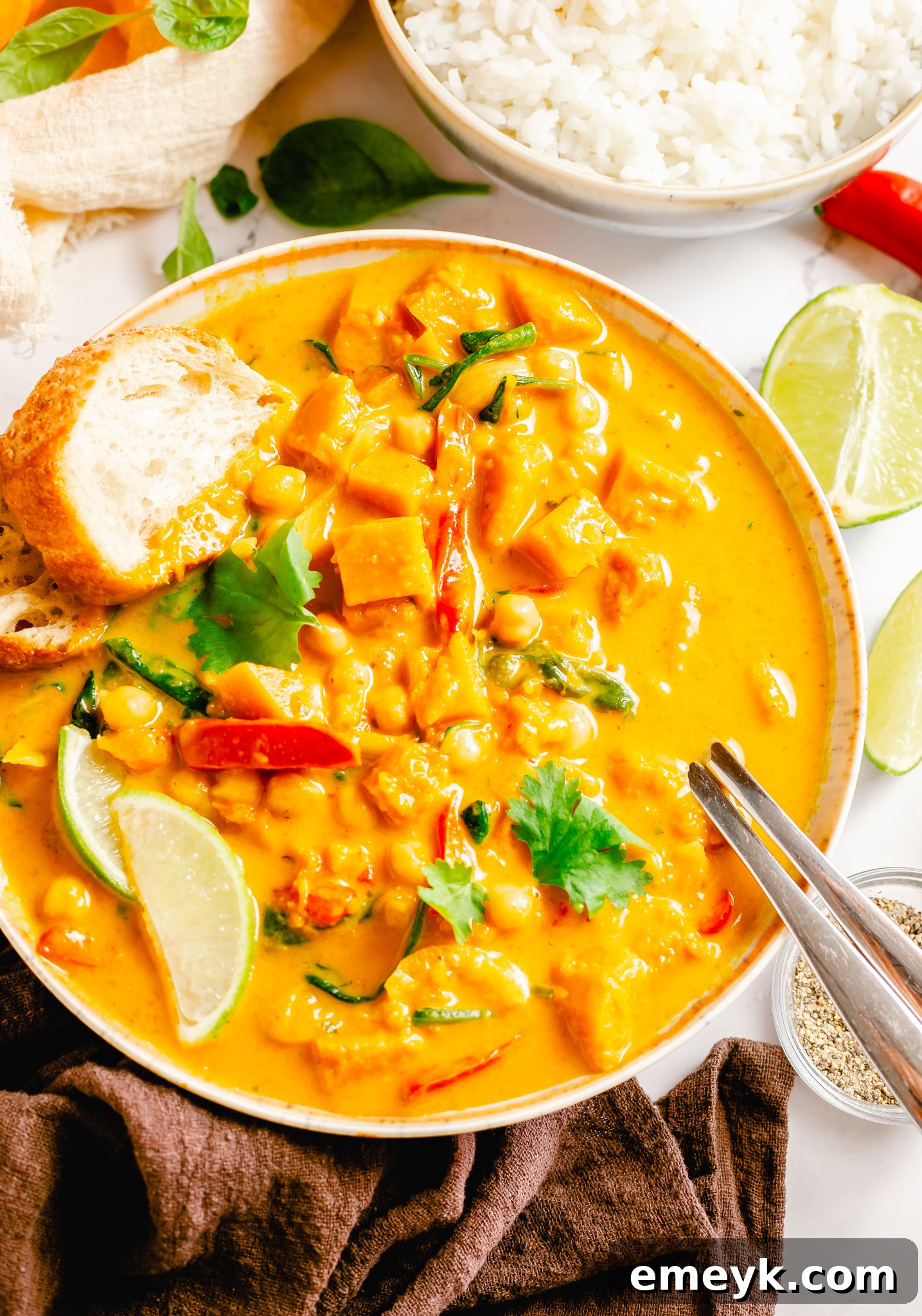 Velvety Pumpkin Curry 8 A close-up of the creamy Pumpkin Curry with a spoon, highlighting its rich texture and ingredients.