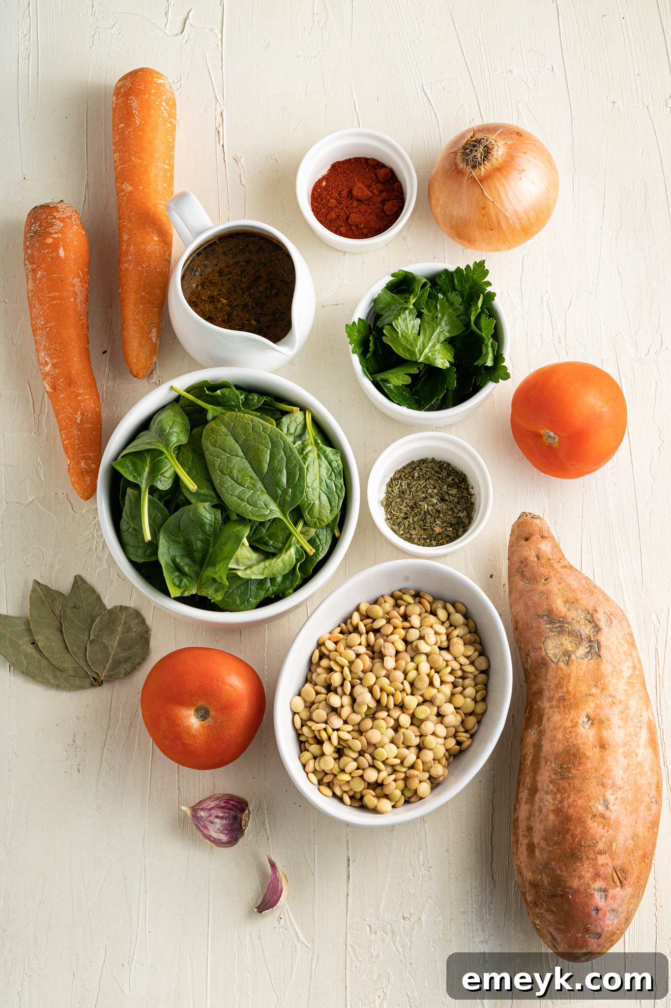 Fresh ingredients laid out for Sweet Potato Lentil Soup, including sweet potatoes, lentils, carrots, celery, and spices.