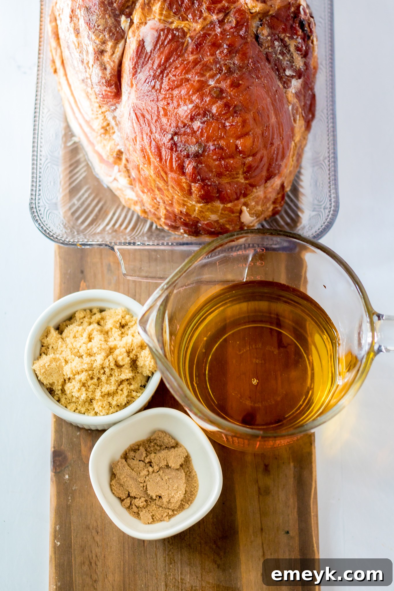 Apple Cider Glazed Ham Recipe ingredients displayed on a cutting board.