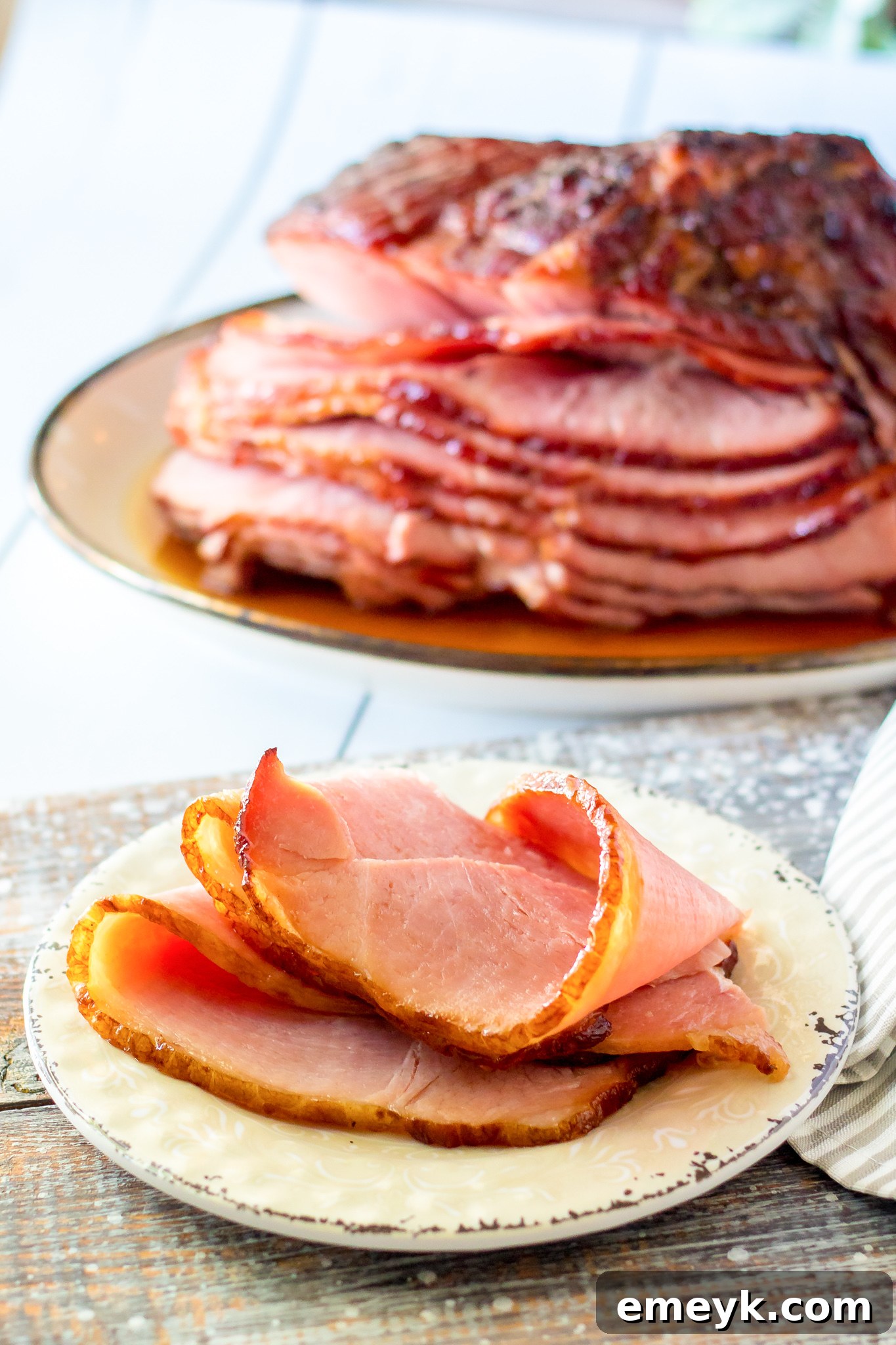 A slice of Apple Cider Glazed Ham on a plate, showing its juicy texture.