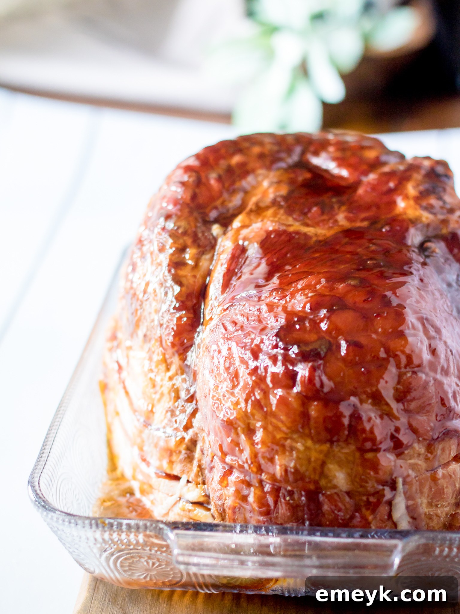 Apple Cider Glazed Ham Recipe ham on a cutting board, resting after baking.