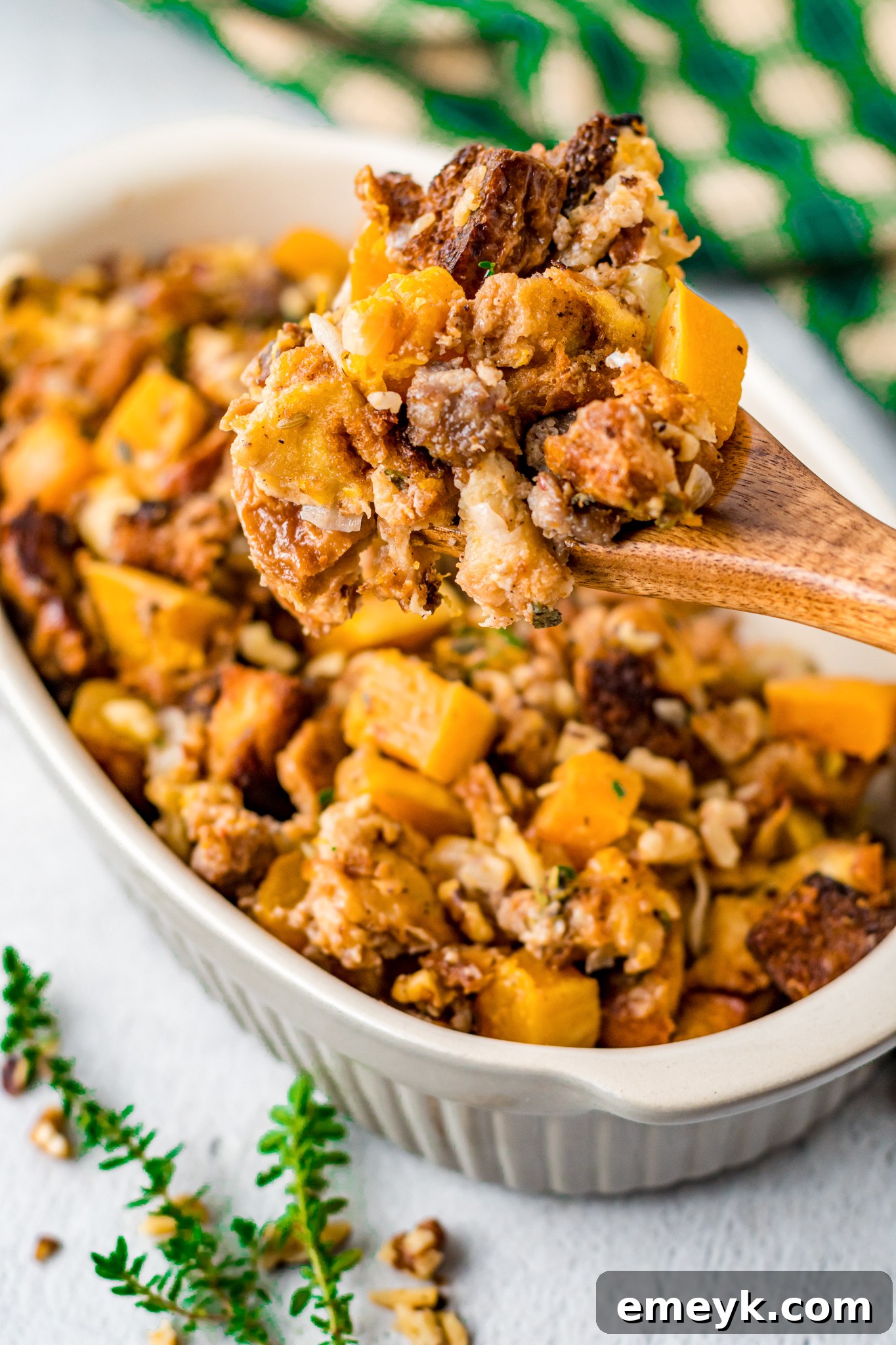 Harvest Butternut Squash Stuffing 11 Butternut Squash Stuffing baked golden in a casserole dish, with a serving fork.