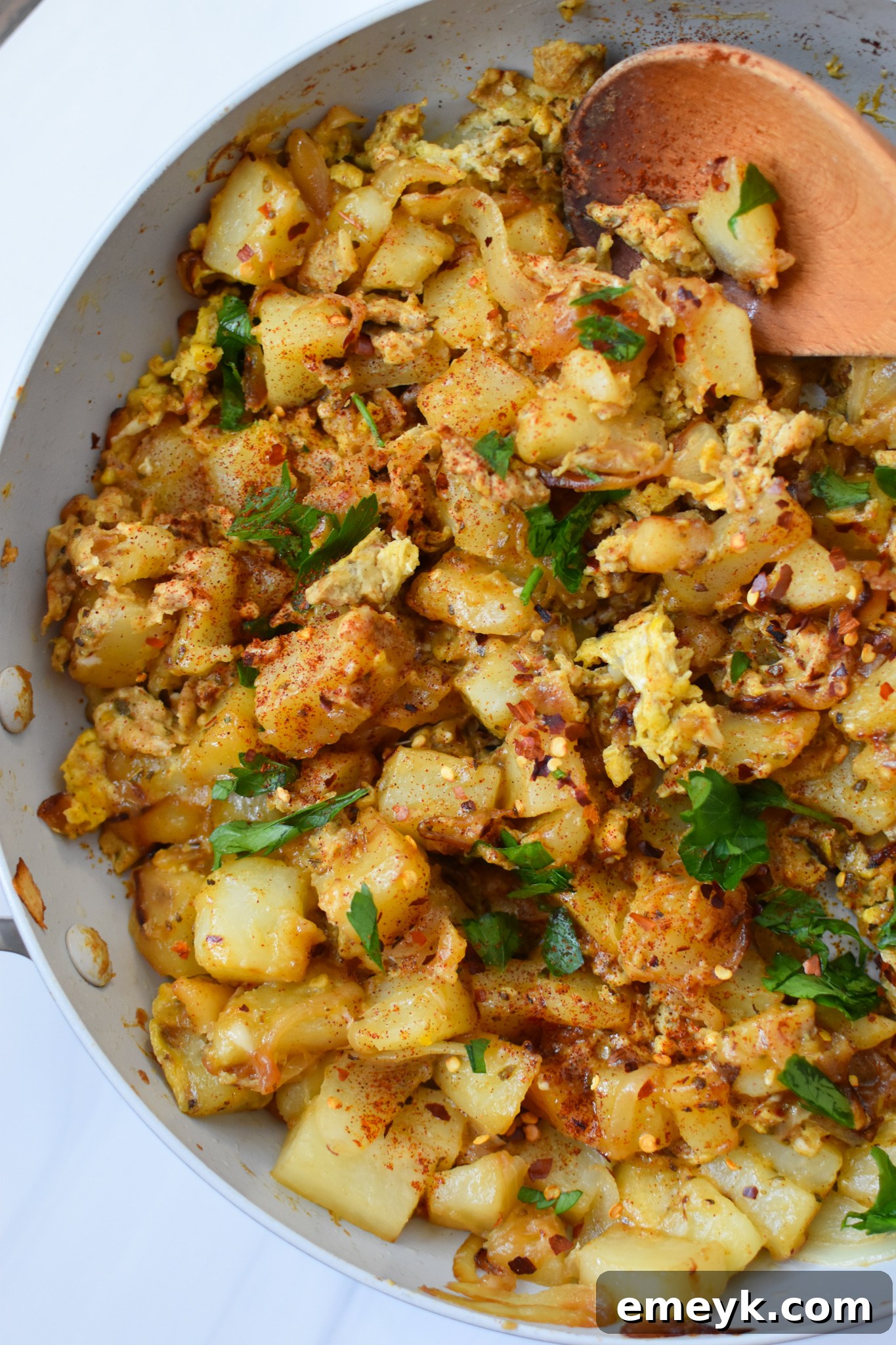 Lebanese Potato and Egg Recipe in a serving dish, garnished with fresh parsley.