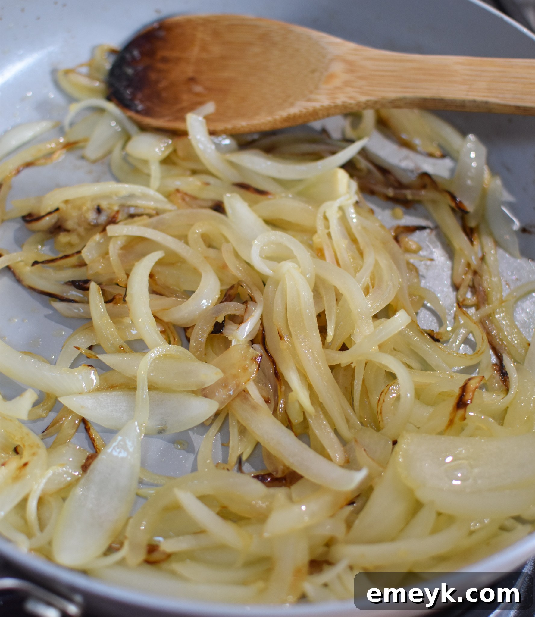 Caramelizing onions and garlic in a skillet for Batata Wa Bayd.