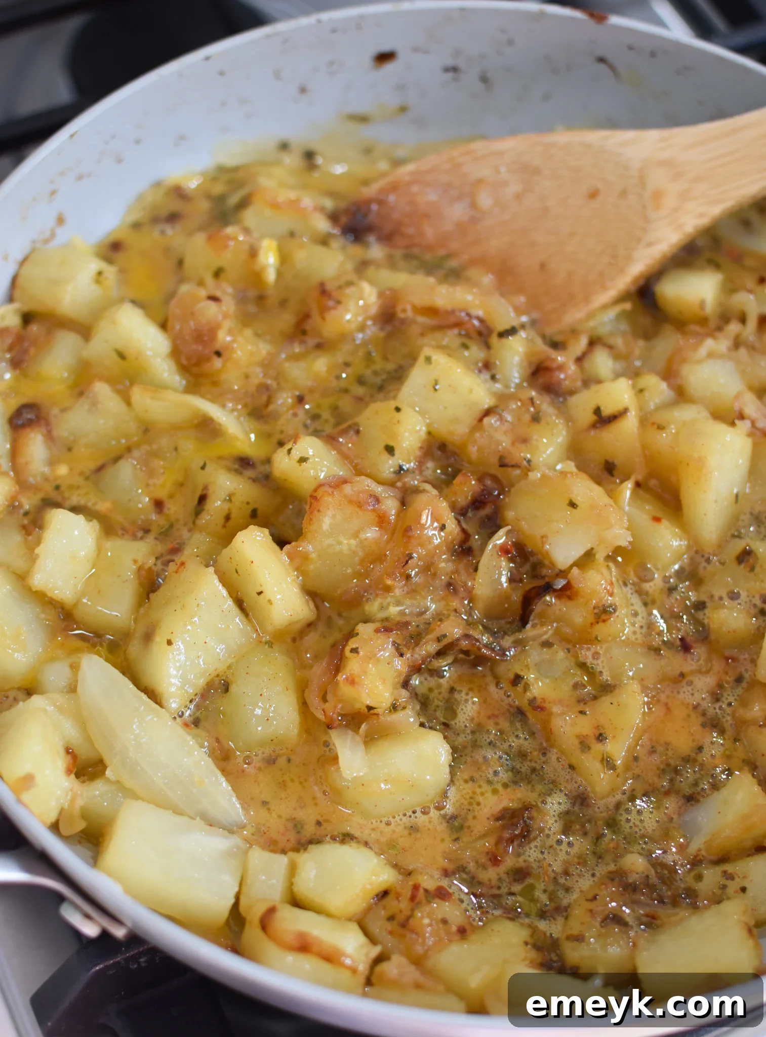 Lebanese Potato and Egg Recipe with eggs cooking in the skillet.