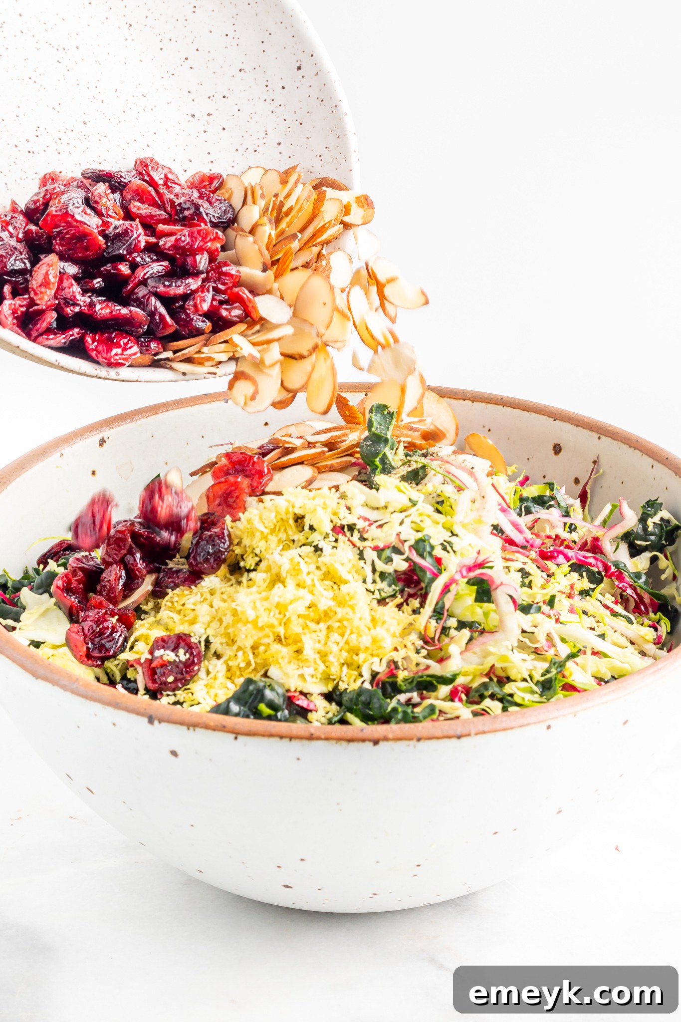 Vibrant Kale Crunch 7 Winter Coleslaw Salad mixing the slaw together.