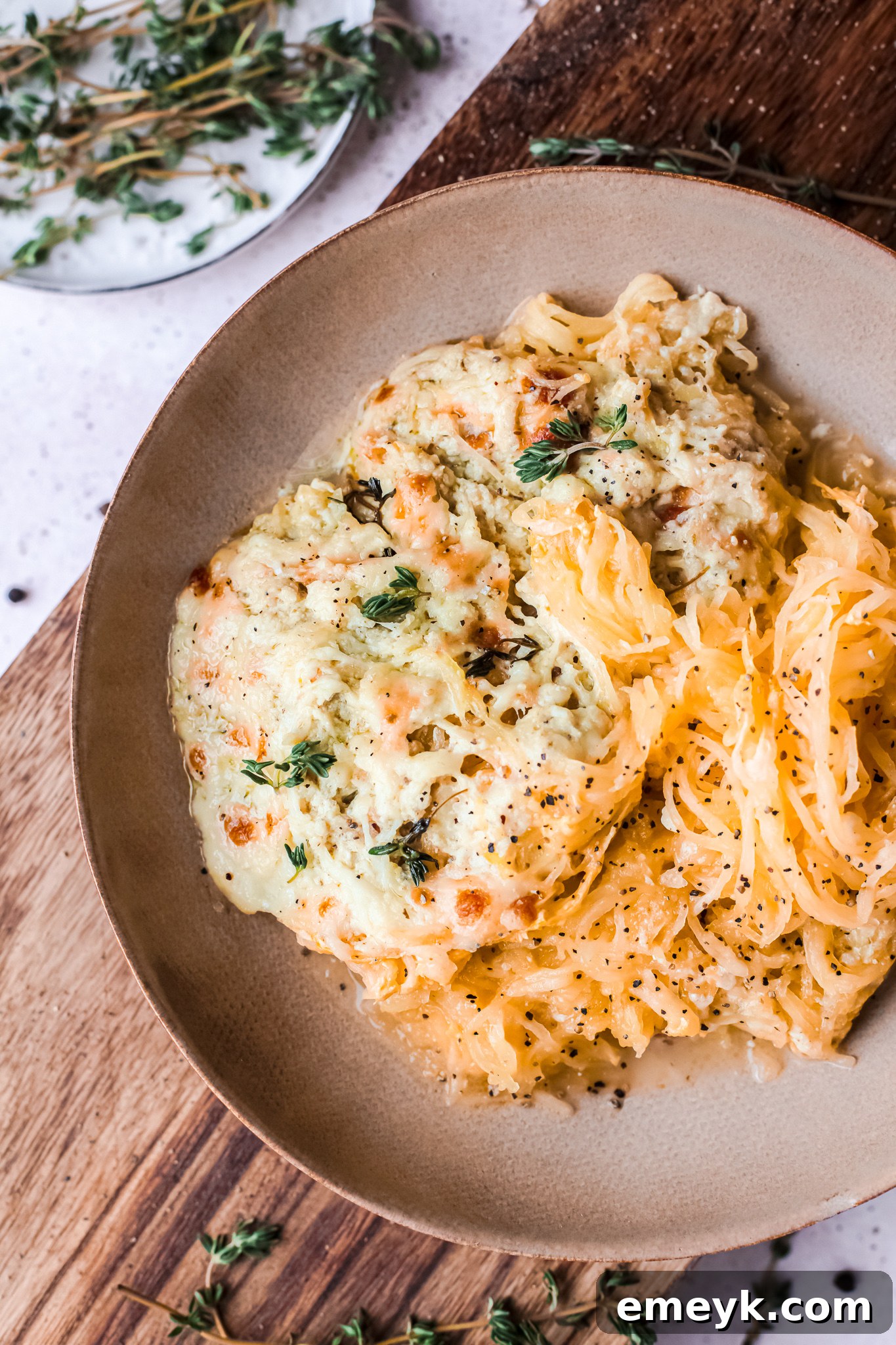 Baked Cheesy Spaghetti Squash Recipe with cheese and fresh herbs.