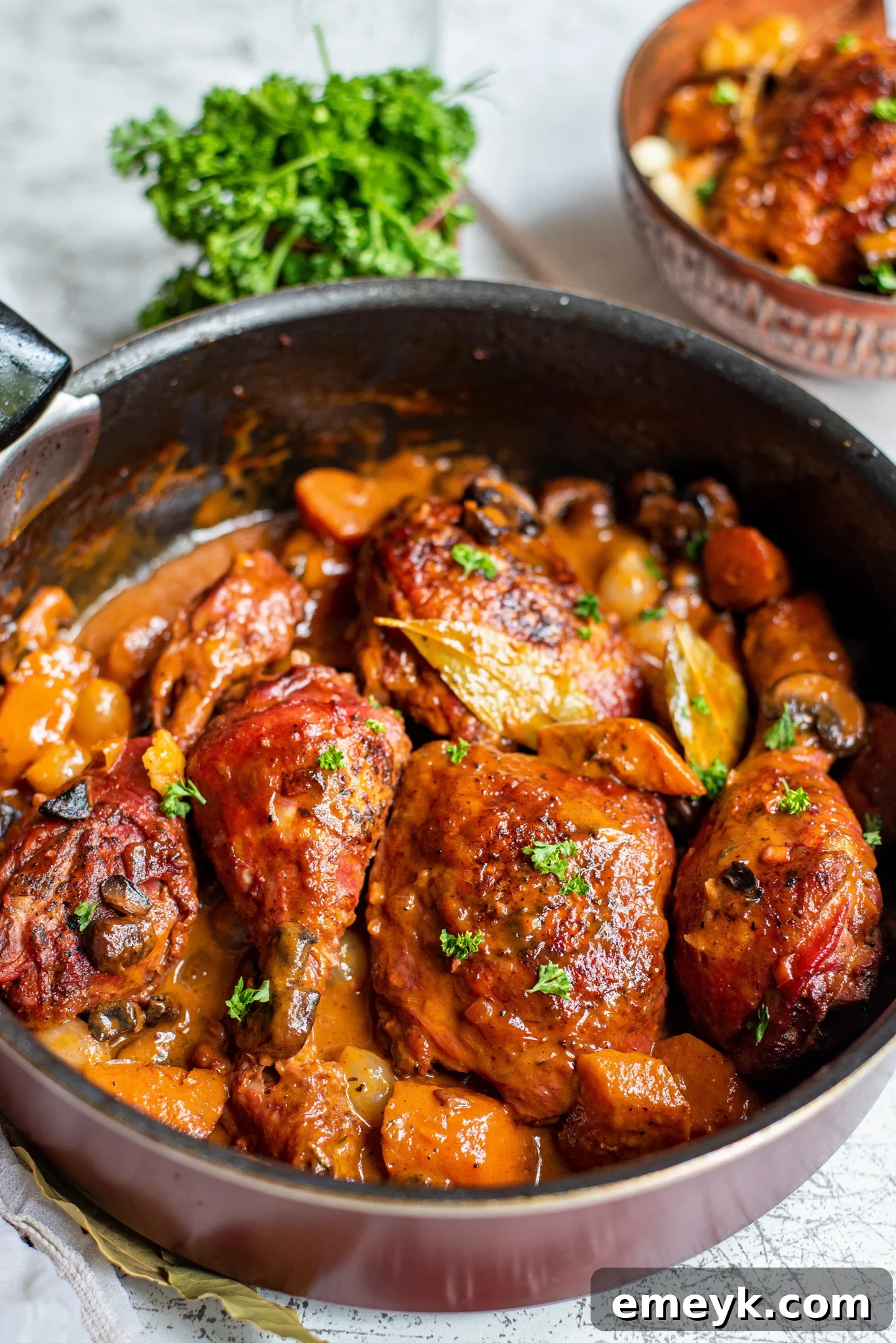 Coq au Vin Recipe cooking in a large Dutch oven.