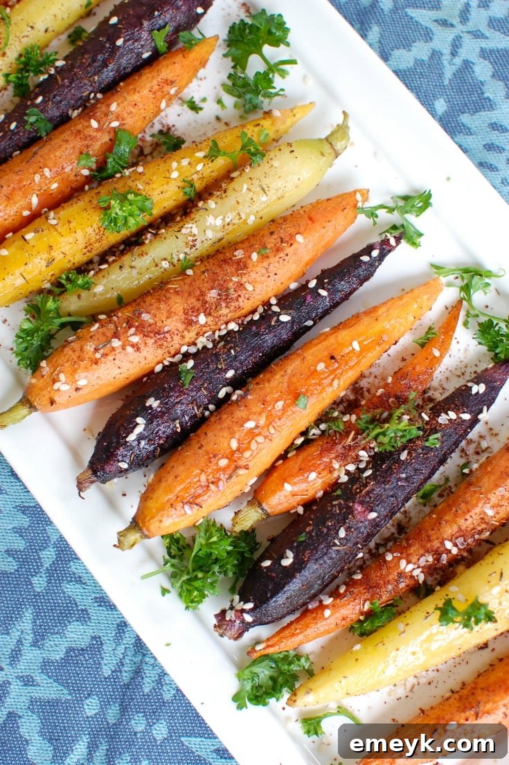 Sweet and earthy Za'atar Roasted Carrots, beautifully caramelized and sprinkled with fresh green herbs, offering an inviting aroma and visual appeal.