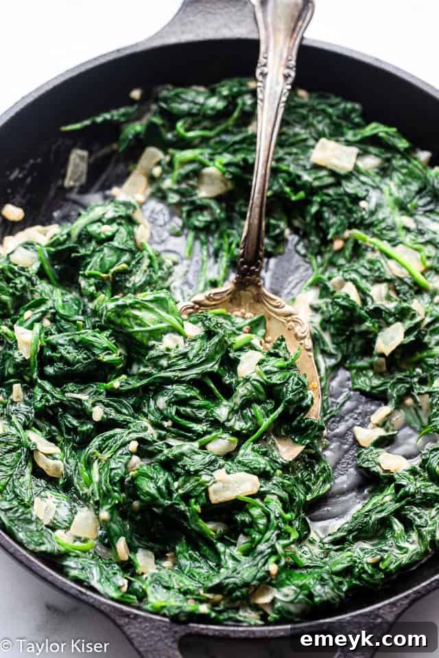 Rich and creamy Low Carb Keto Creamed Spinach, served warm in a white dish, a perfect indulgent yet healthy green vegetable side.