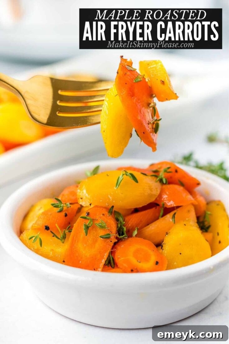 Perfectly cooked Maple Roasted Air Fryer Carrots, lightly caramelized and glistening with a sweet glaze, garnished with fresh green herbs.