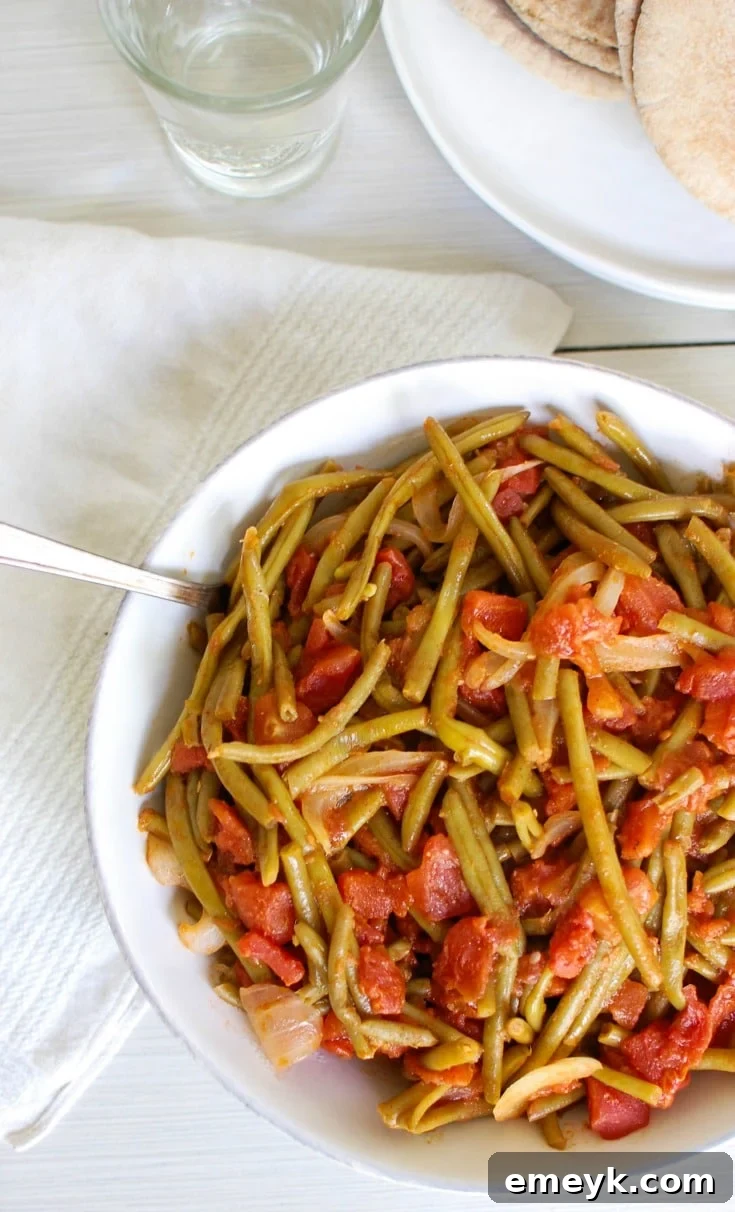Authentic Lebanese Green Beans (Lubee) stewed with ripe tomatoes and olive oil, a comforting and deeply flavored Mediterranean dish.