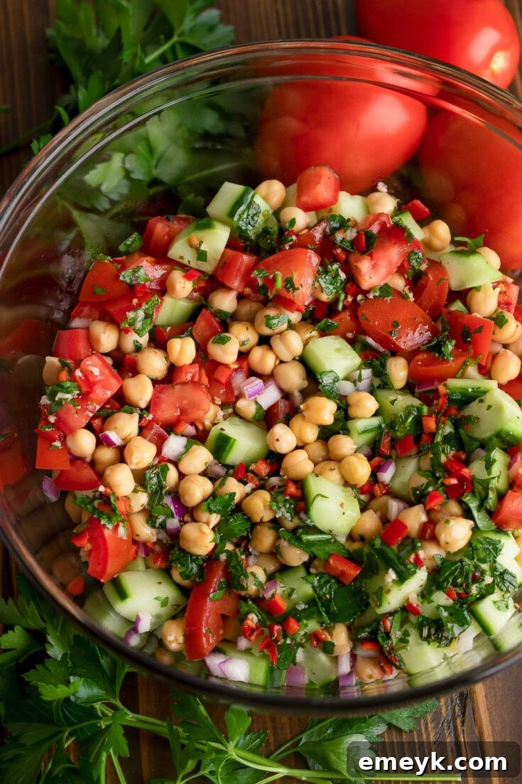 A vibrant and protein-packed Chimichurri Chickpea Salad, bursting with colorful bell peppers, fresh cilantro, and chickpeas coated in a zesty chimichurri dressing.