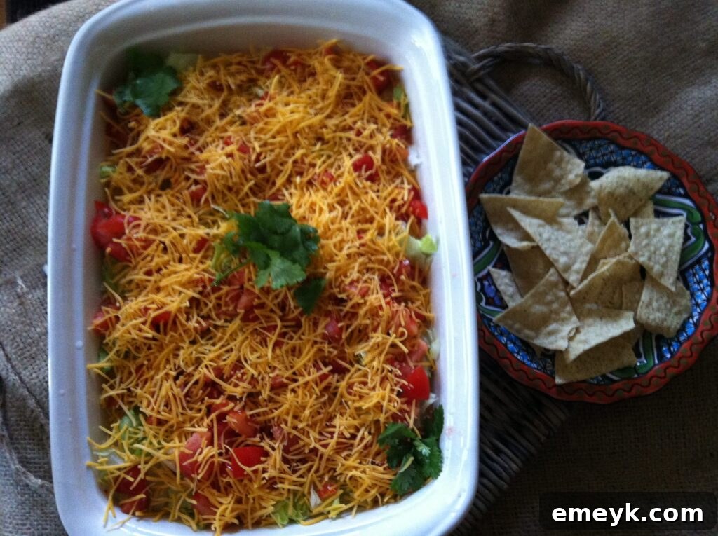Skinny Seven Layer Dip appetizer on a table with chips