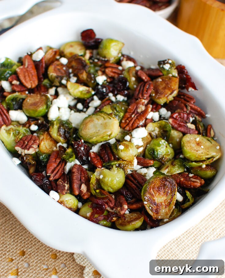 Roasted Brussels Sprouts with festive additions of blue cheese, walnuts, and dried cranberries.