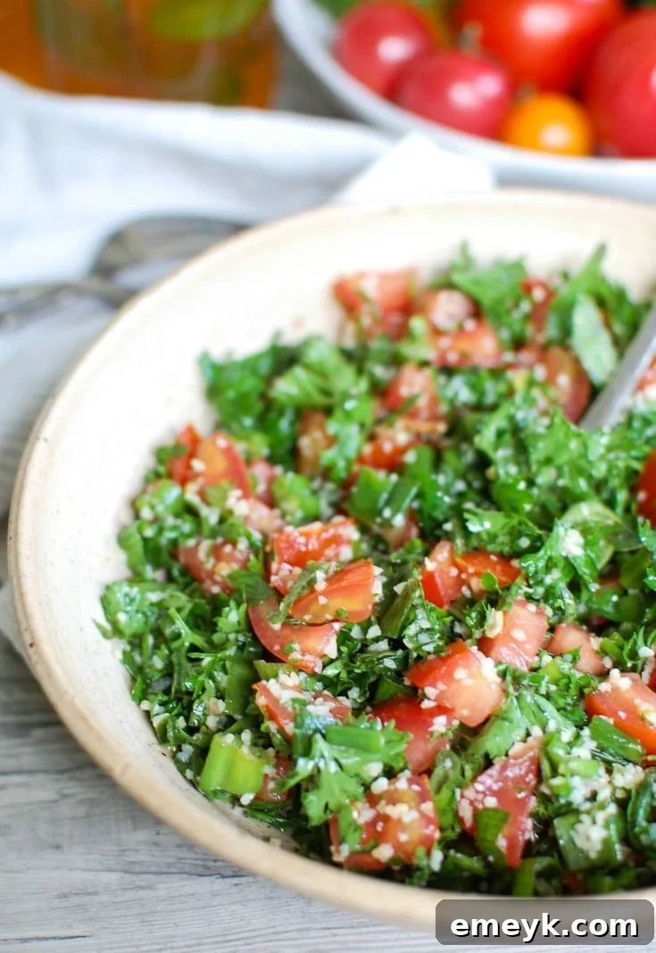 Fresh Lebanese Tabbouleh salad bursting with finely chopped parsley, ripe tomatoes, refreshing mint, and delicate bulgur wheat, dressed in lemon and olive oil.