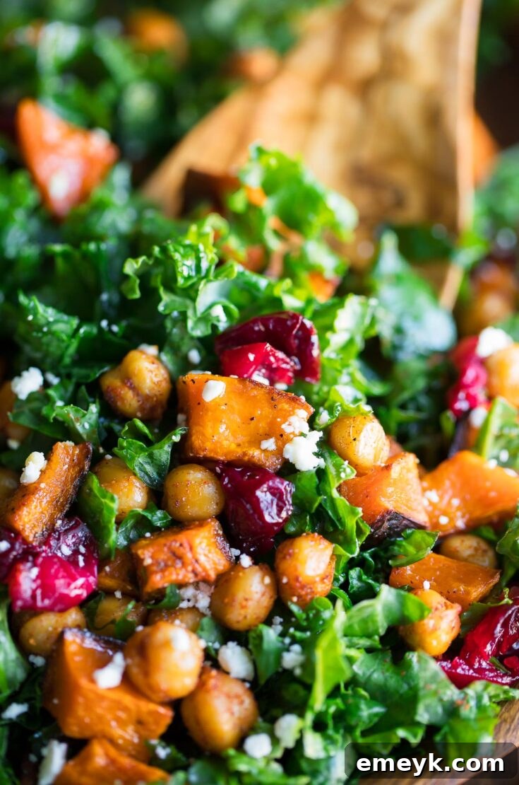 Hearty and flavorful Roasted Butternut Squash Kale Salad with chickpeas and cranberries, perfect for a festive meal.
