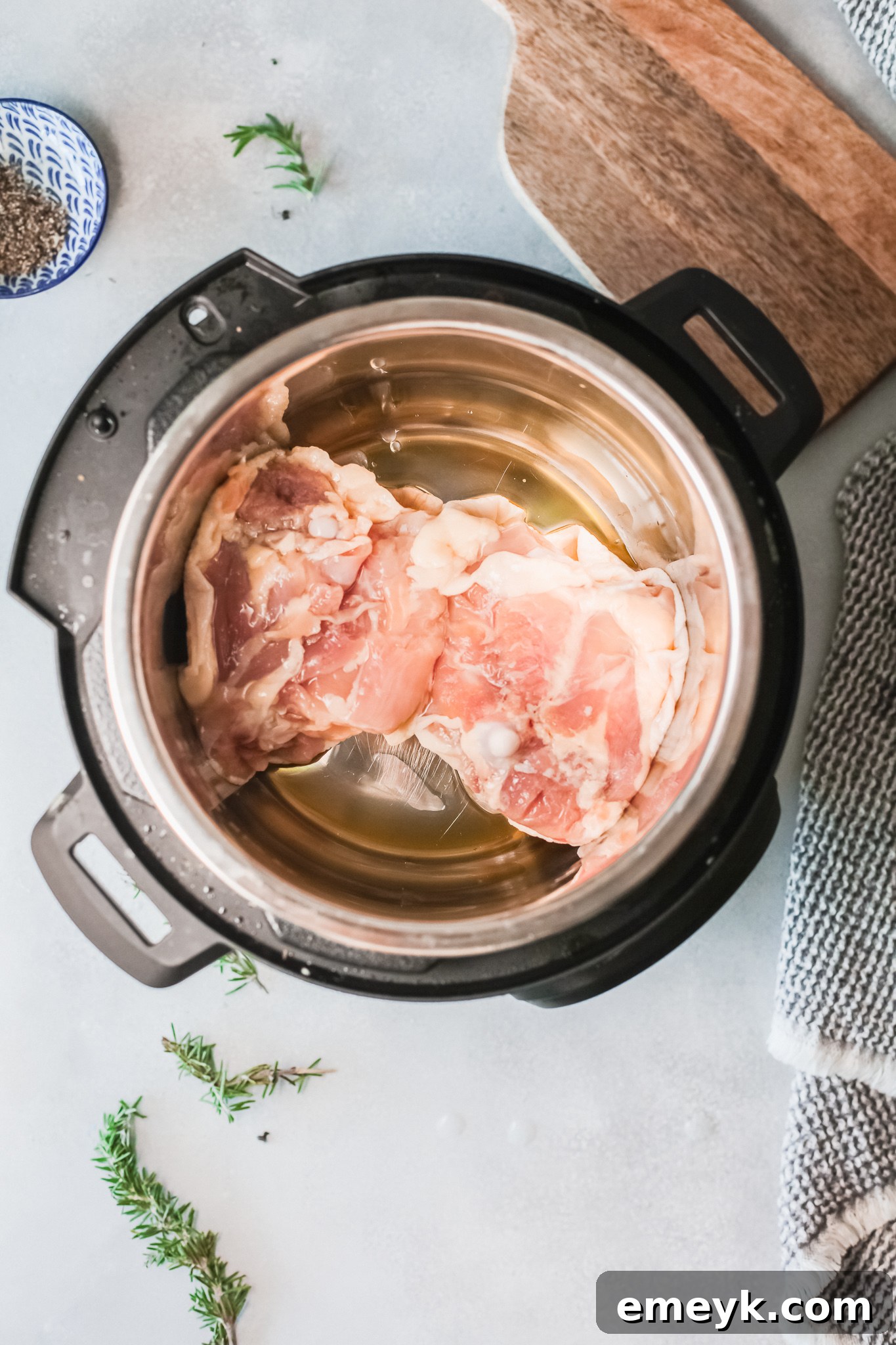 Instant Pot Creamy Rosemary Chicken thighs browning in the Instant Pot.