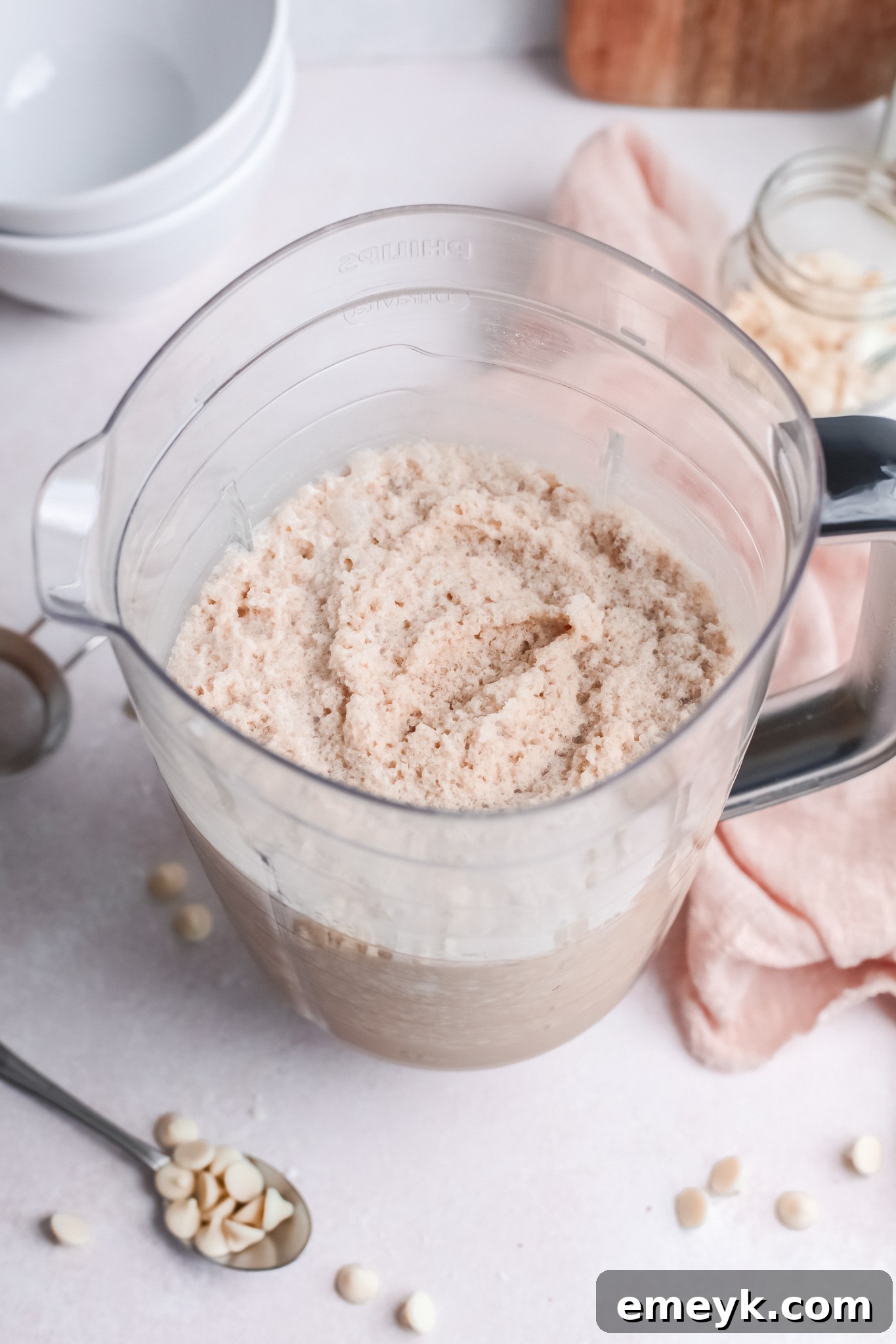 The blended liquid base for a White Chocolate Frappuccino in a blender, showing a smooth, creamy texture before ice is added for freezing.