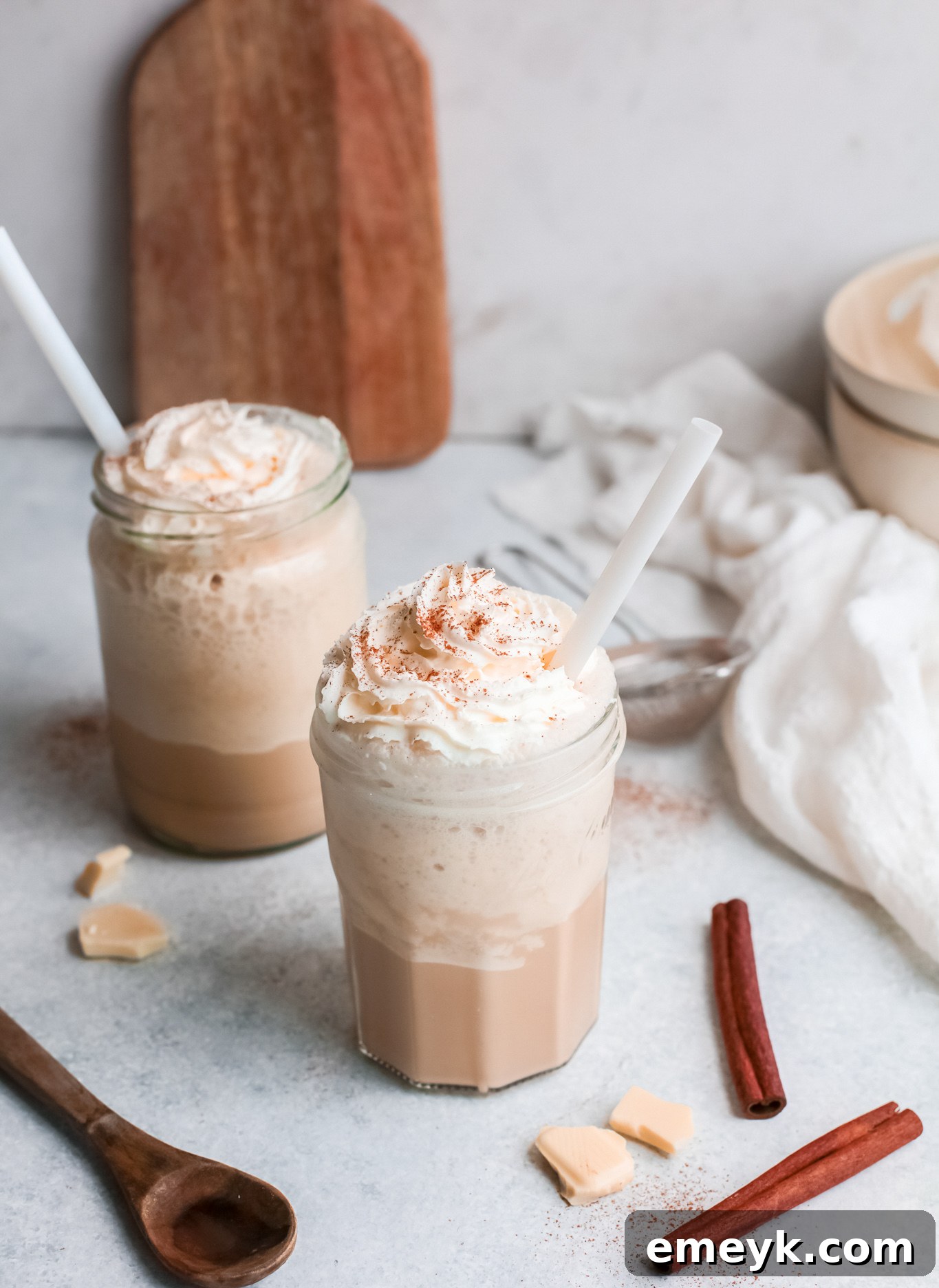 Two glasses of White Chocolate Frappuccino, beautifully topped with whipped cream and two straws, ready to be enjoyed as a shared treat.