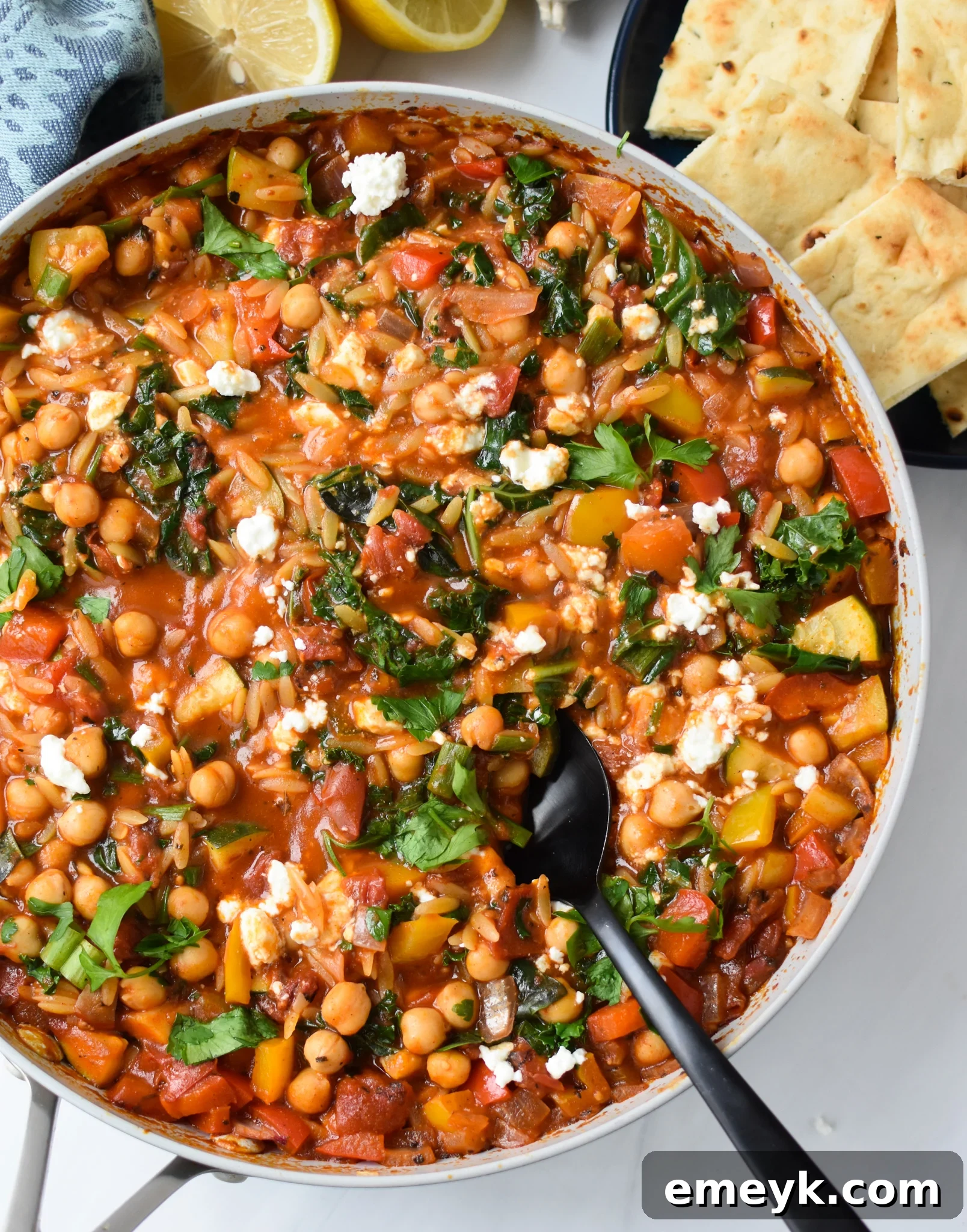 Vibrant Mediterranean Orzo Pasta 2 A vibrant pan of Mediterranean Orzo Pasta, showcasing the mix of orzo, chickpeas, tomatoes, and herbs, ready to be served.