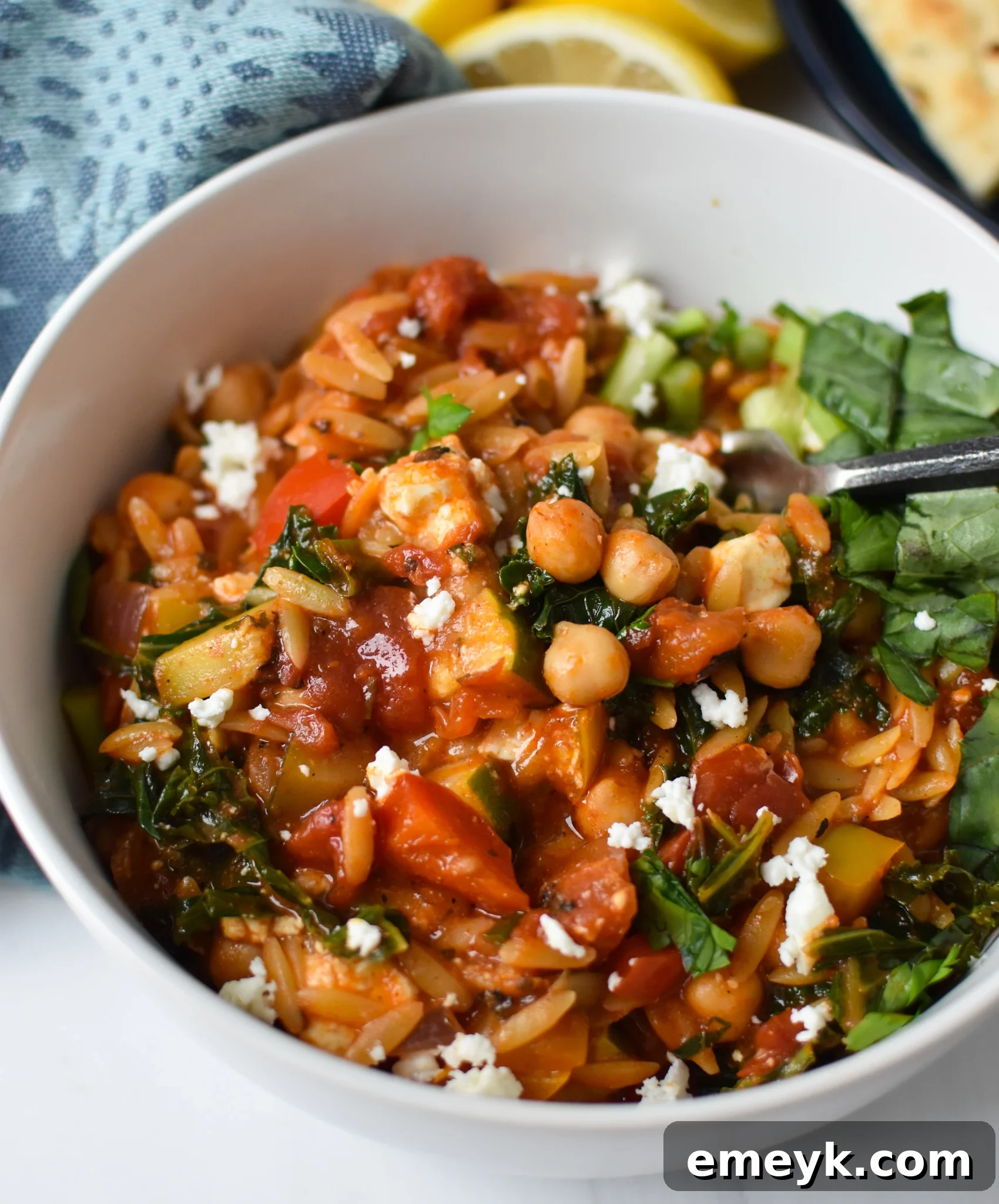 Vibrant Mediterranean Orzo Pasta 4 Mediterranean Orzo Pasta simmering in a pan, showcasing the vibrant ingredients.