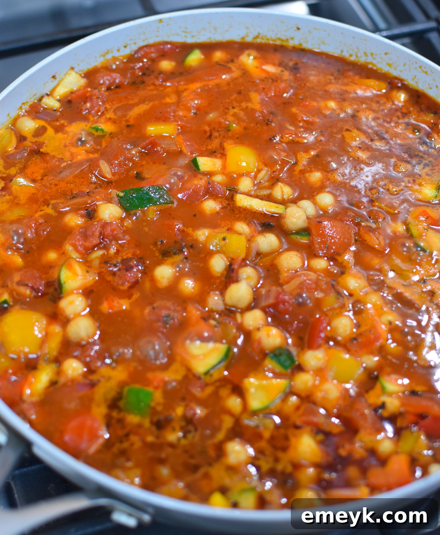 Vibrant Mediterranean Orzo Pasta 6 Mediterranean Orzo Pasta simmering gently in a pot, absorbing the rich broth.
