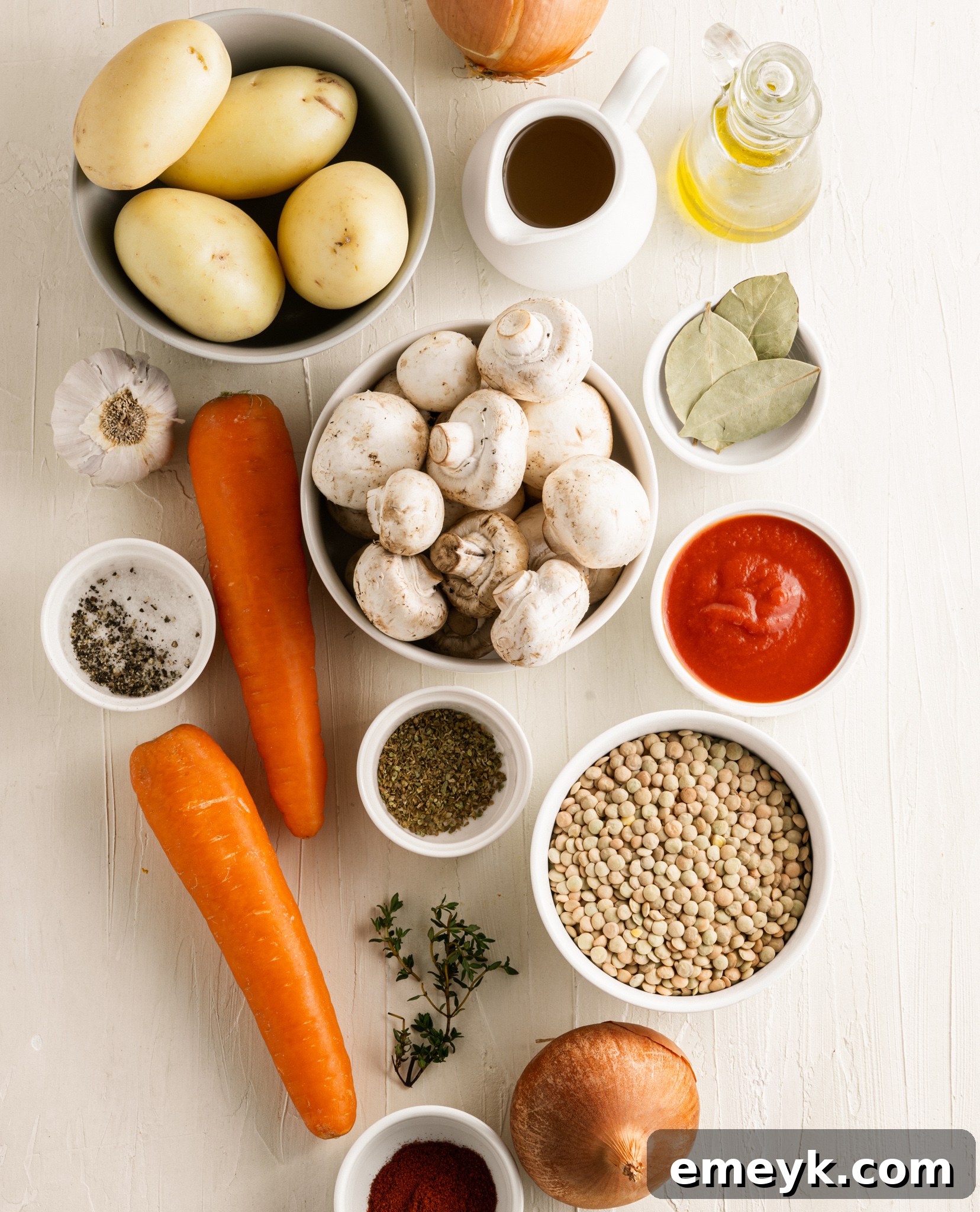 Hearty Lentil Mushroom Stew 5 A selection of fresh ingredients for Lentil Mushroom Stew, including mushrooms, carrots, onions, and spices.