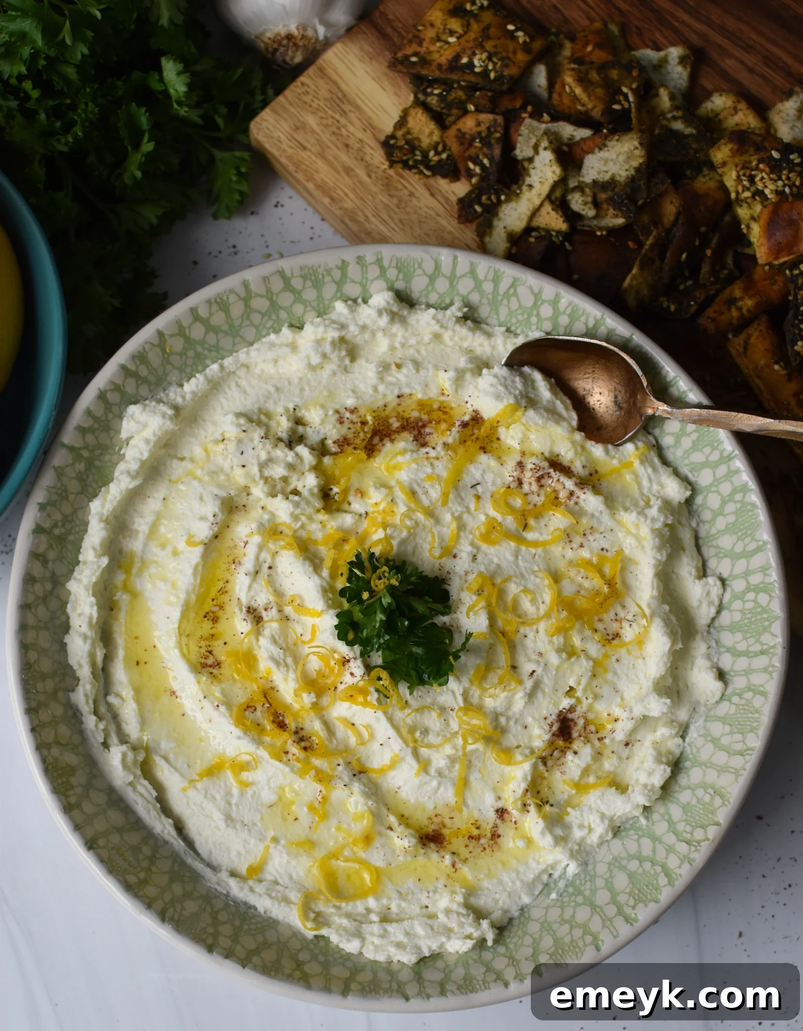 Lemon Whipped Feta Dip with a serving spoon in a bowl.