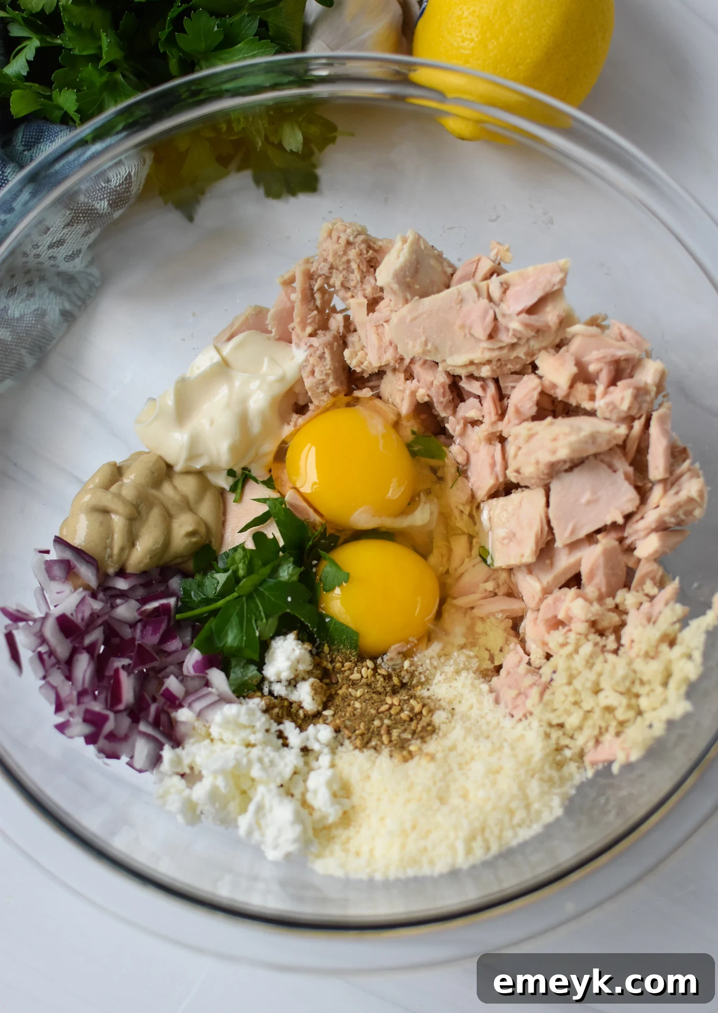 Sun Kissed Mediterranean Tuna Fritters 5 All ingredients for Mediterranean Tuna Patties mixed in a bowl.