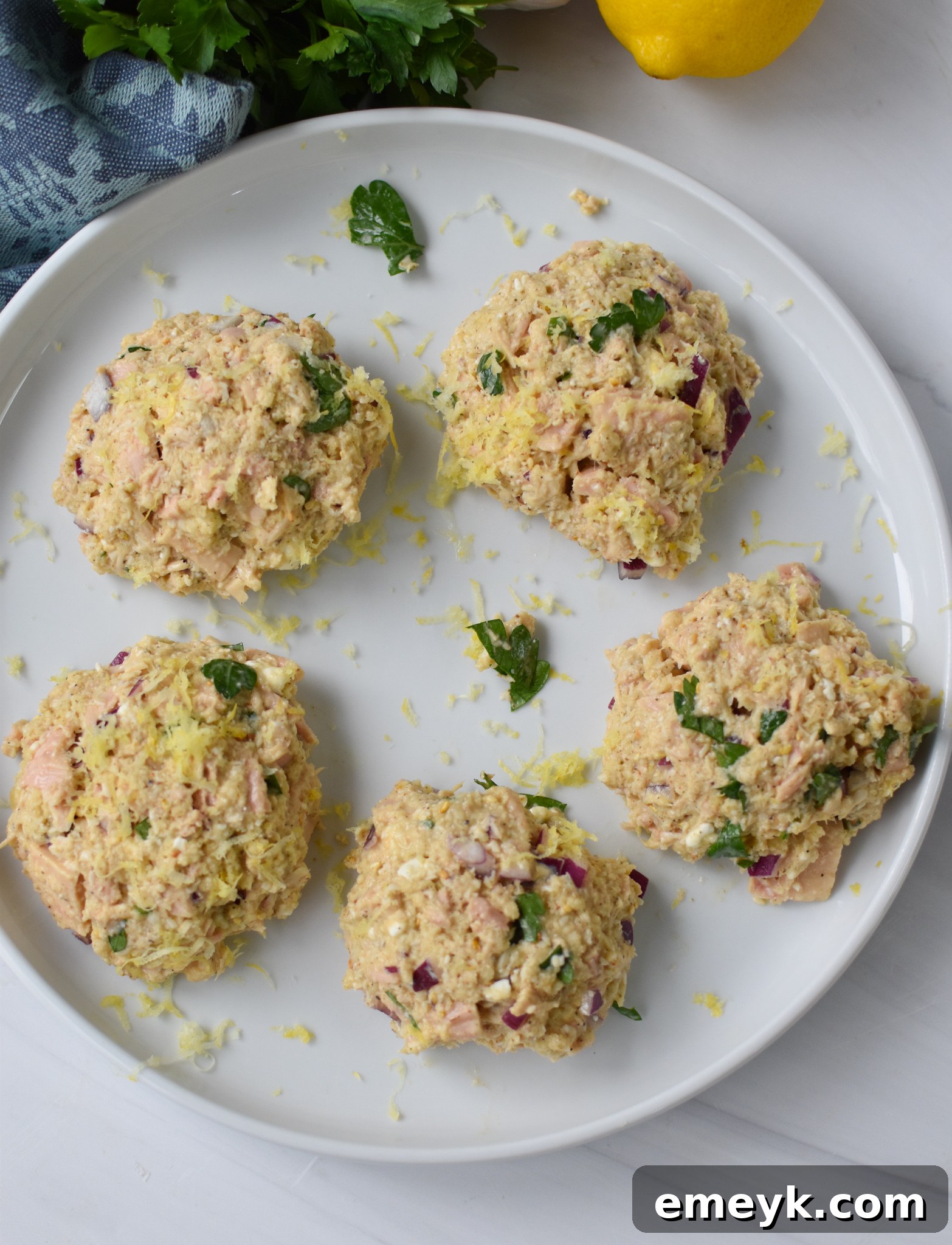 Sun Kissed Mediterranean Tuna Fritters 7 Mediterranean Tuna Patties formed into cakes on a platter.