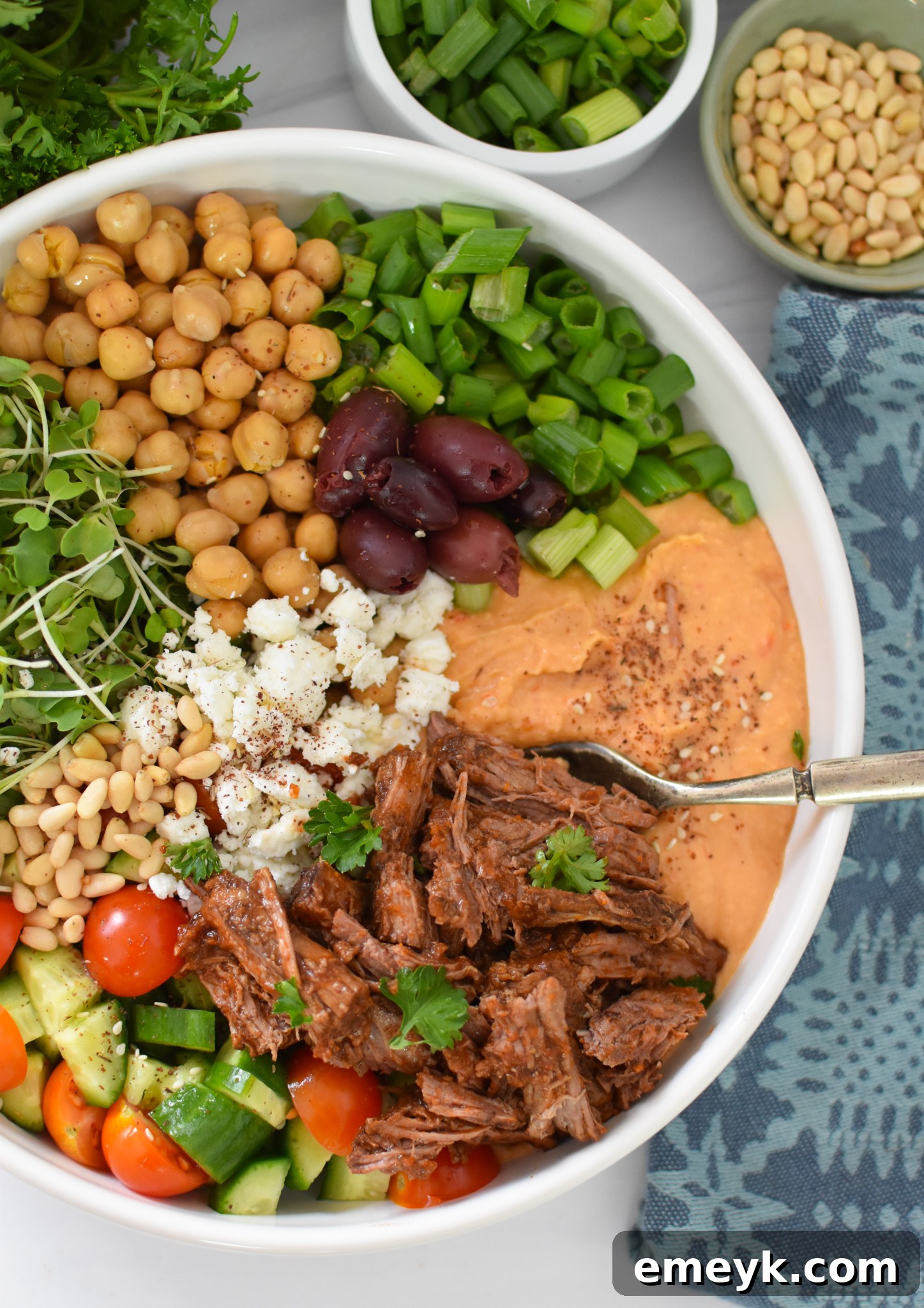 Slow Cooker Shredded Beef Hummus Bowls with shredded Mediterranean beef in a vibrant bowl of fresh ingredients and creamy hummus.