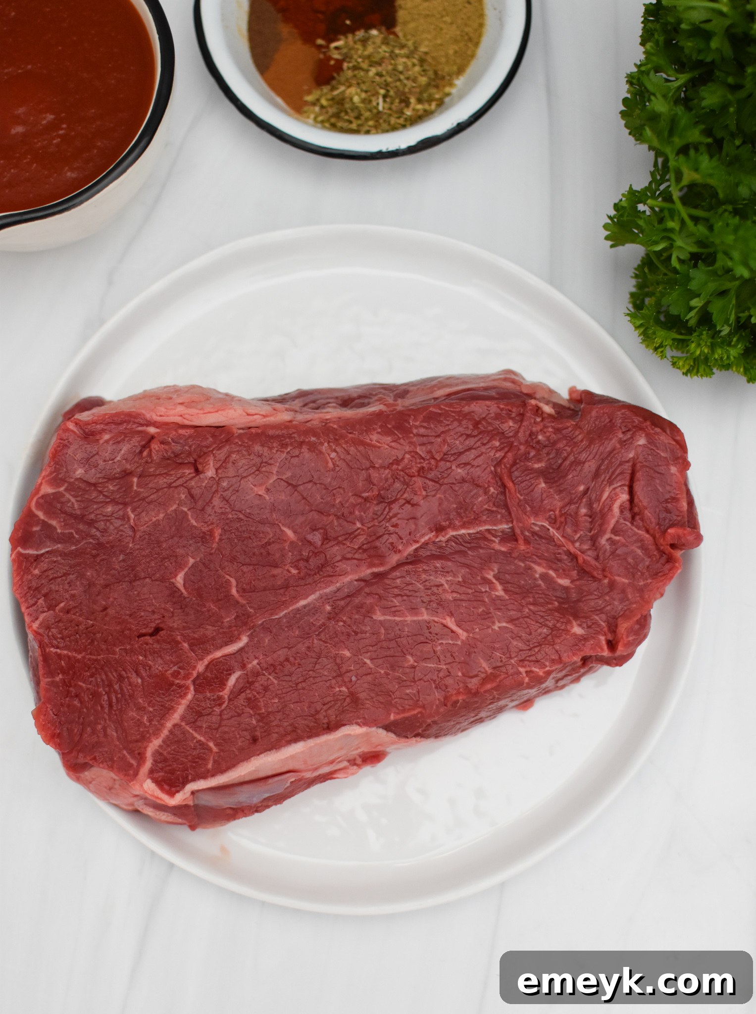 Close-up of slow cooked shredded beef, perfect for hummus bowls, showing its tender texture.