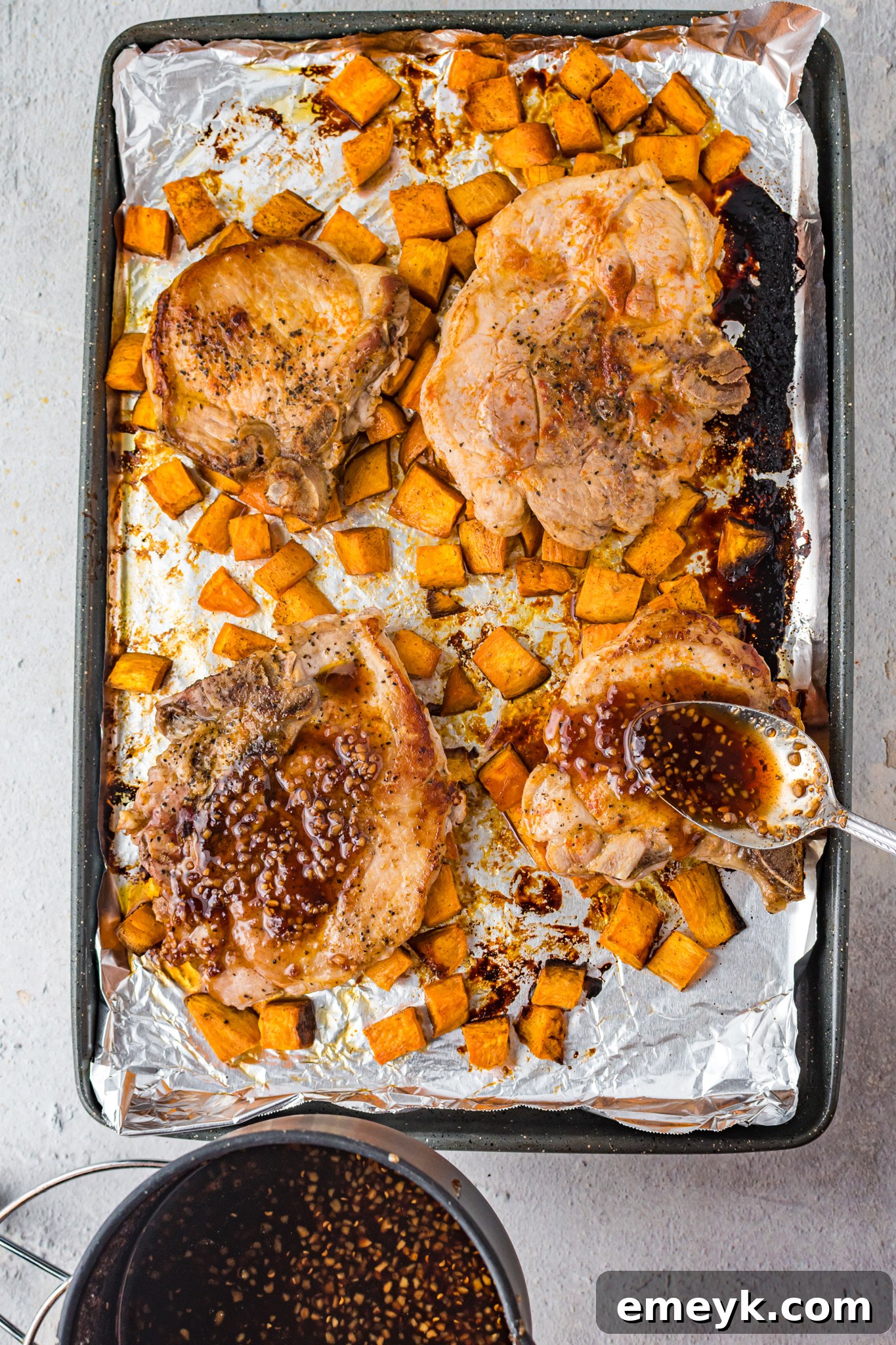 Maple Bourbon Pork Chops with ample glaze drizzled over them on a platter.