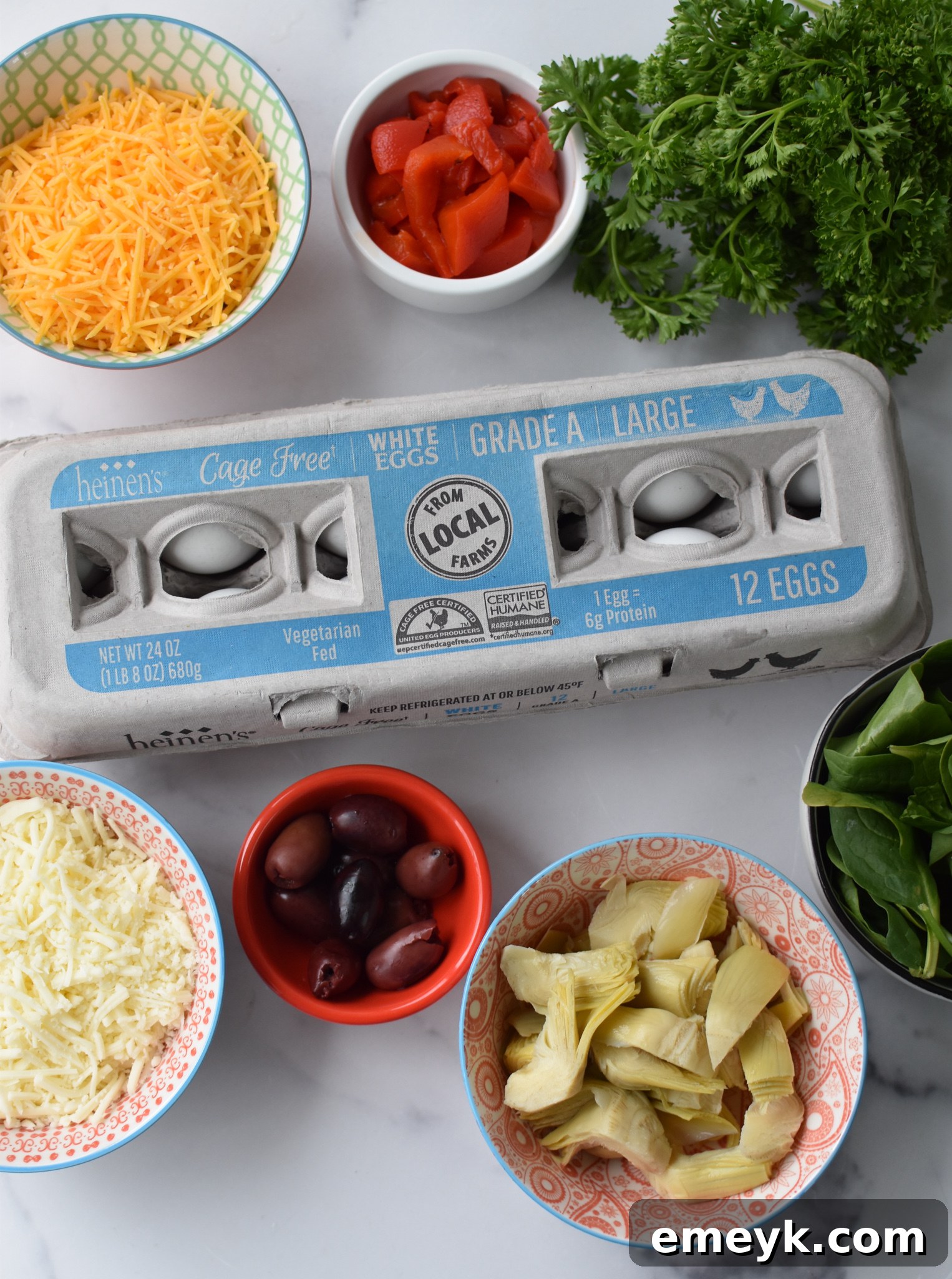 All the fresh ingredients laid out for the Mediterranean Vegetable Frittata Recipe, including eggs, vegetables, and cheeses.