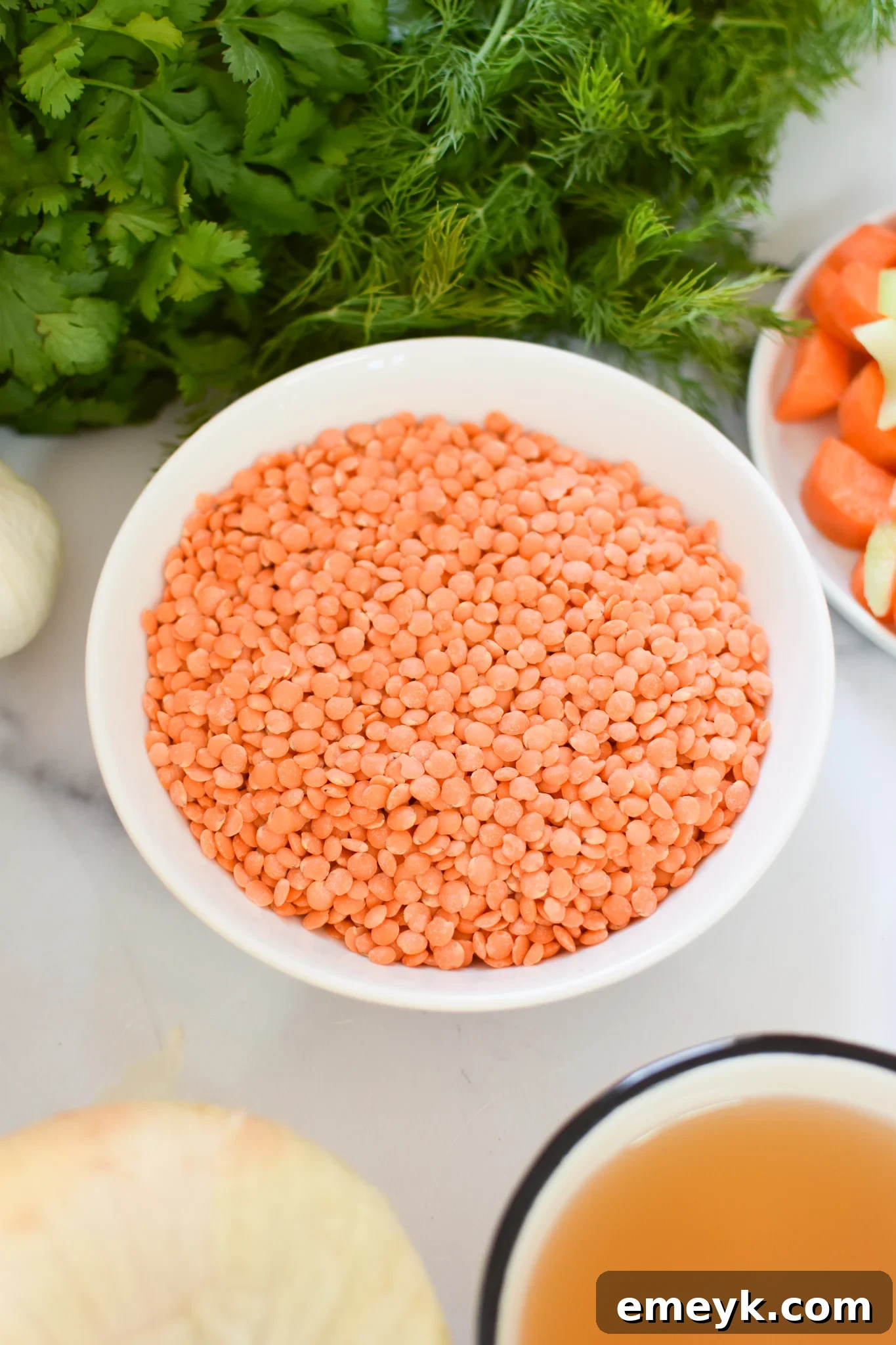 Close-up of red lentils in a bowl, ready for cooking.