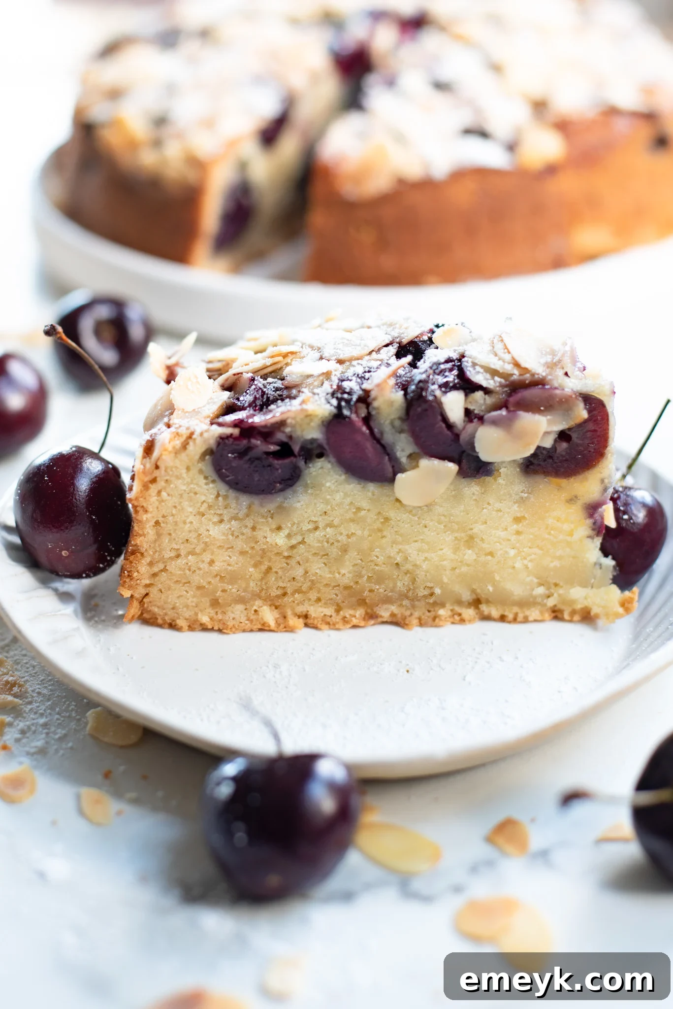 Decadent Cherry Almond Cake 6 A slice of Cherry Almond Cake with a fork, ready to be enjoyed.