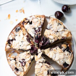 Decadent Cherry Almond Cake 9 Cherry Almond Cake with cherries and almonds on a plate.