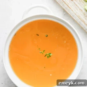 Homemade Chicken Broth in a white bowl.