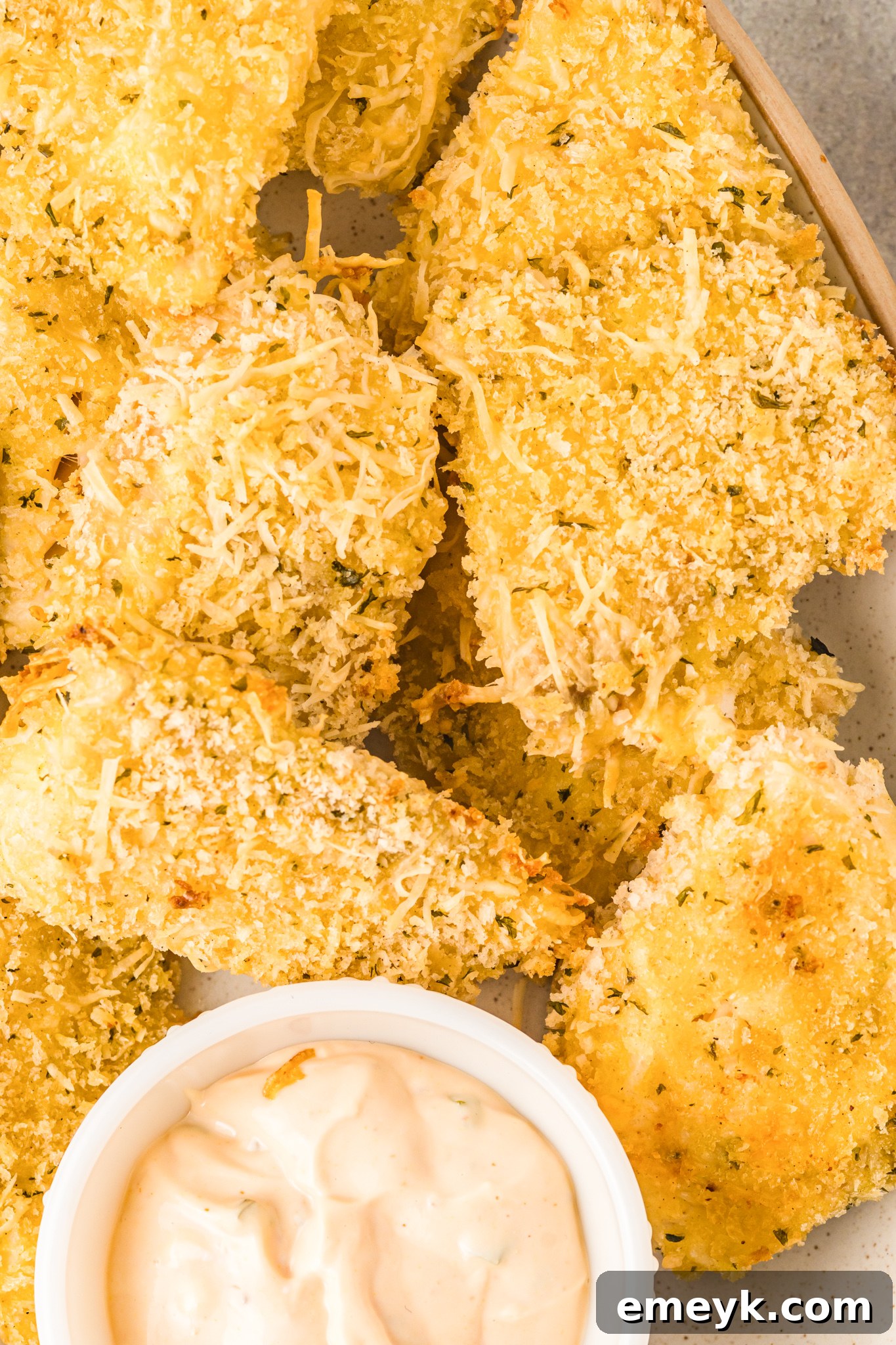 Crispy Baked Parmesan Fish Sticks with creamy dipping sauce.